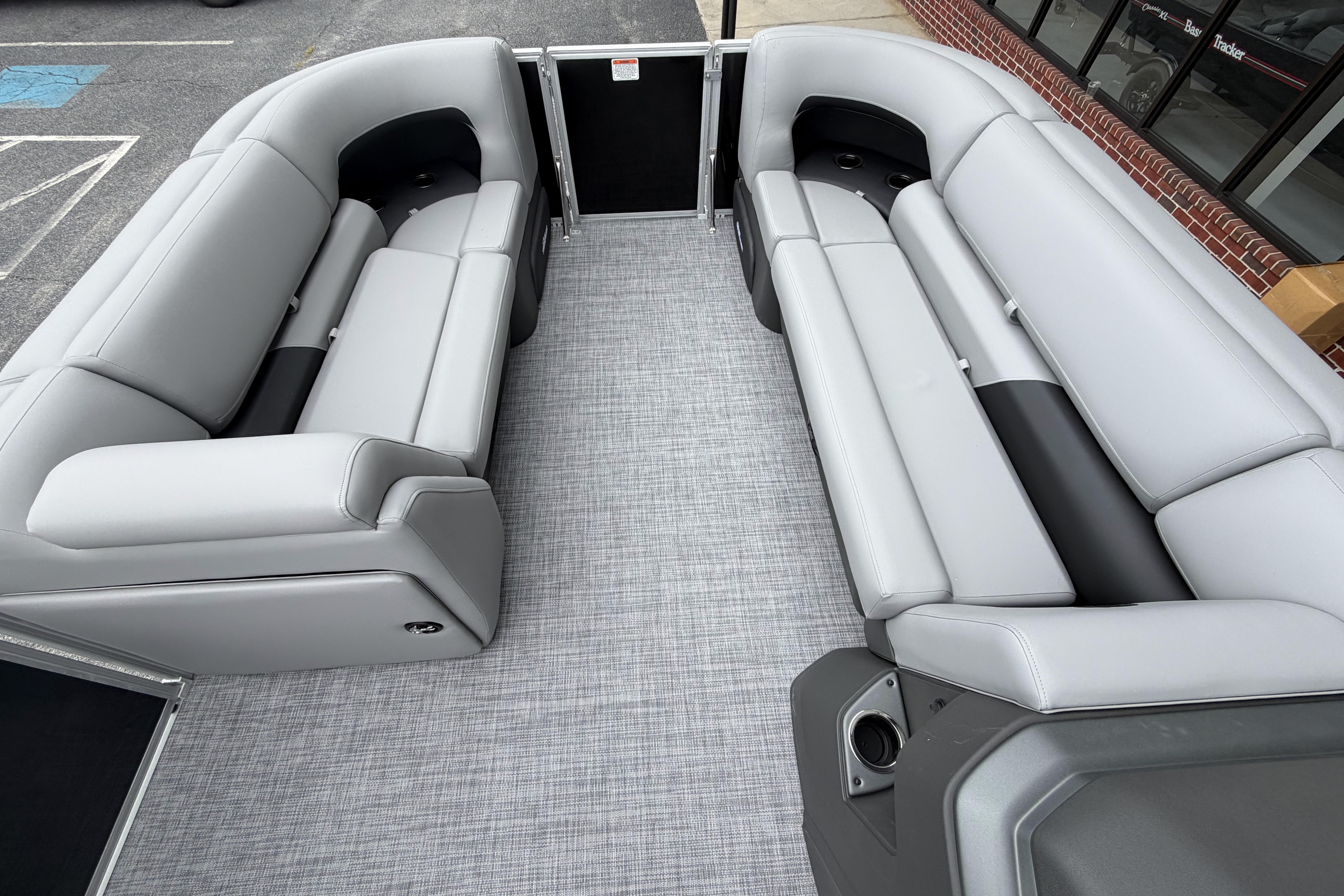 2026 Sun Tracker Party Barge 20 DLX interior with spacious gray seating and modern design.