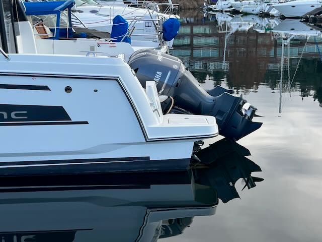 A 2021 Jeanneau NC 1095 is on the water, featuring a Yamaha outboard motor.