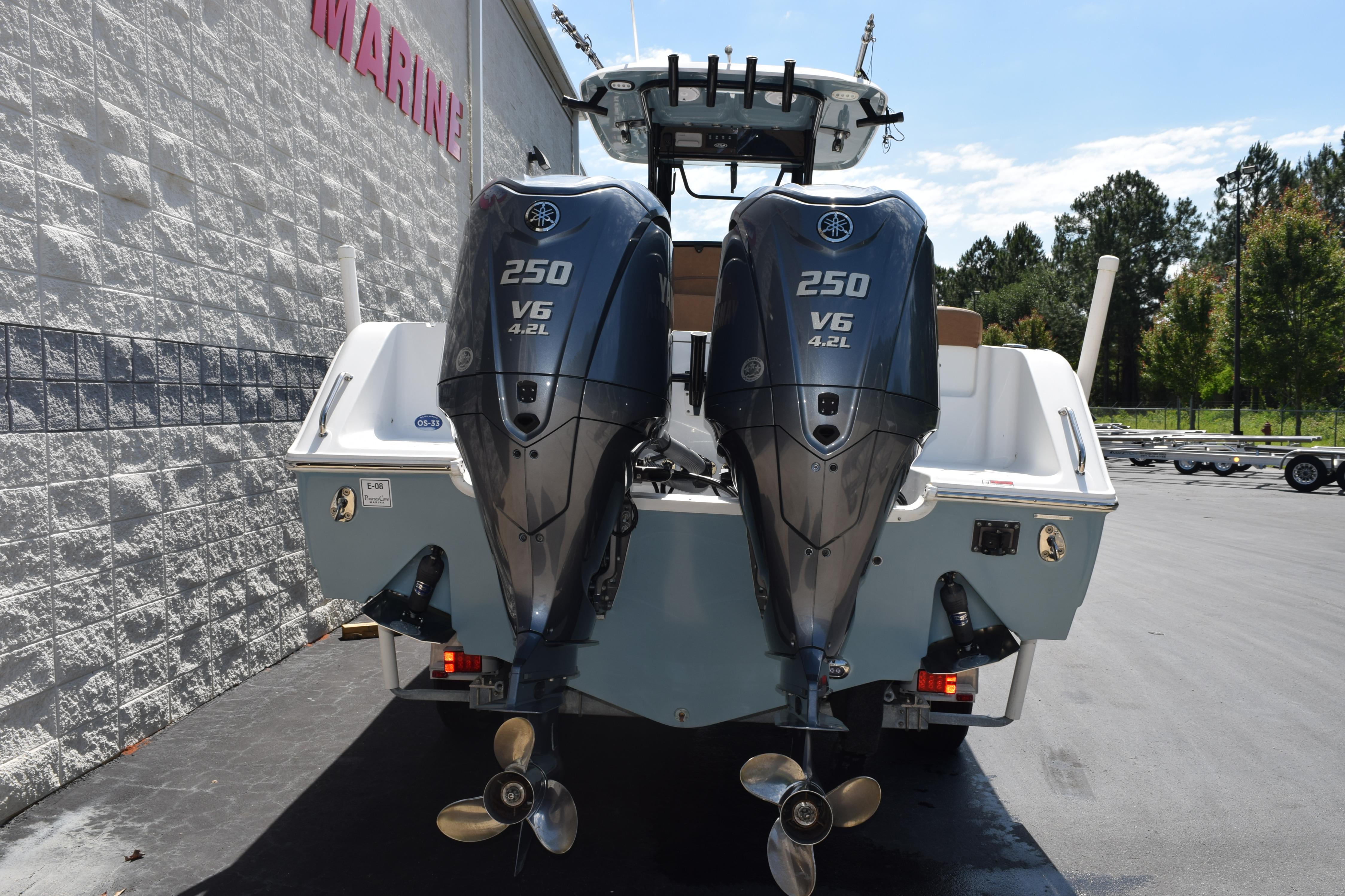 2022 Sea Hunt Gamefish 27 with twin Yamaha 250 V6 engines, parked outdoors.