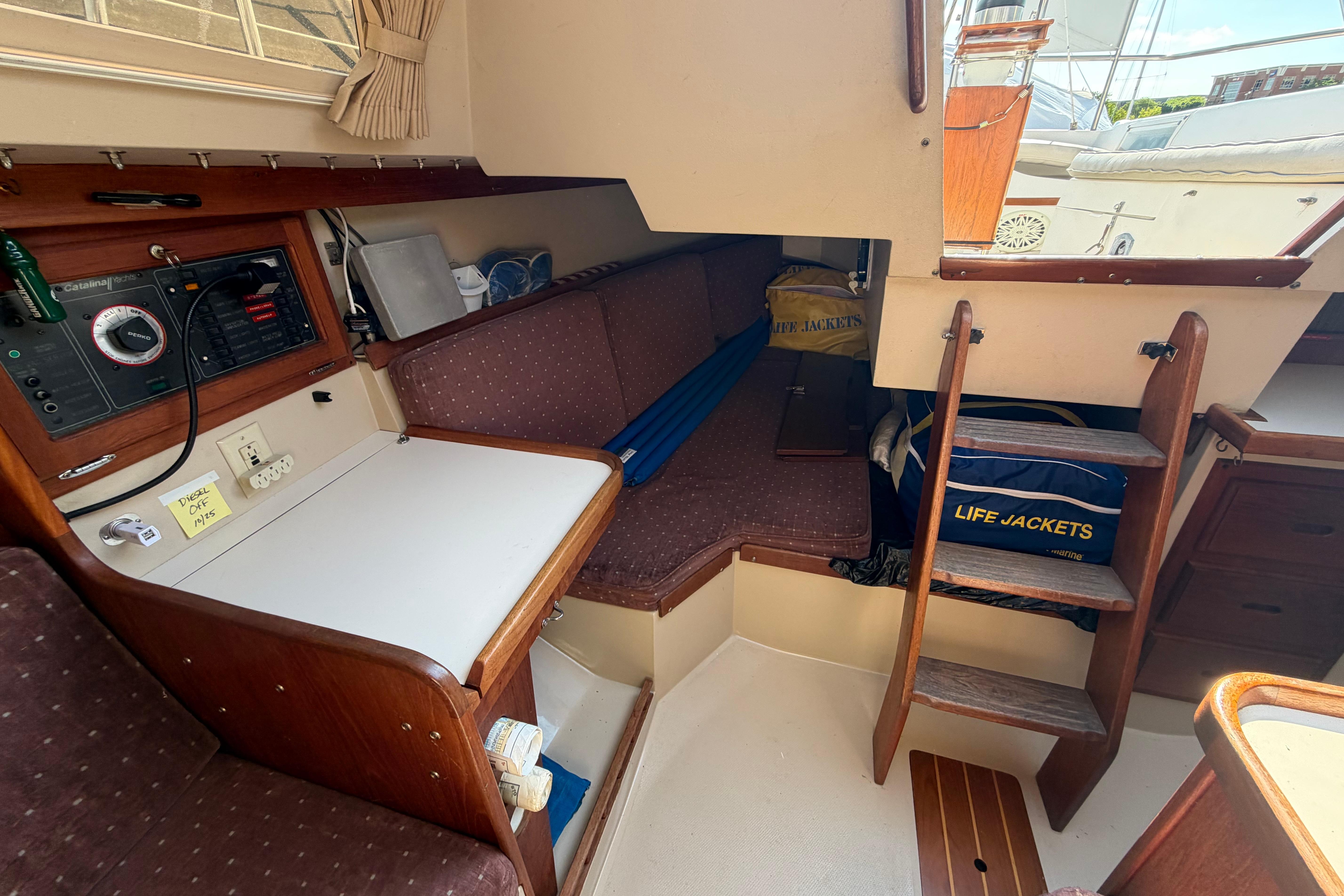 Interior of a 1988 Catalina 30 MkII sailboat with navigation station and seating area.