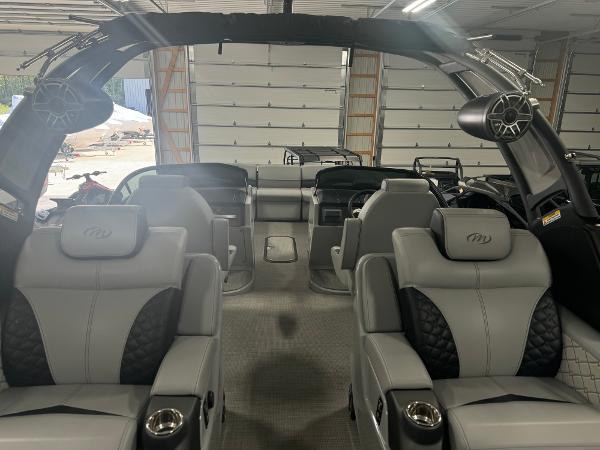 Interior of 2025 Manitou LX boat with luxurious seating and modern design.