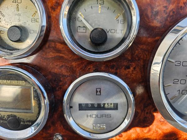 Close-up of 1997 Bayliner 26 Cierra dashboard gauges, showing voltmeter and hour meter.