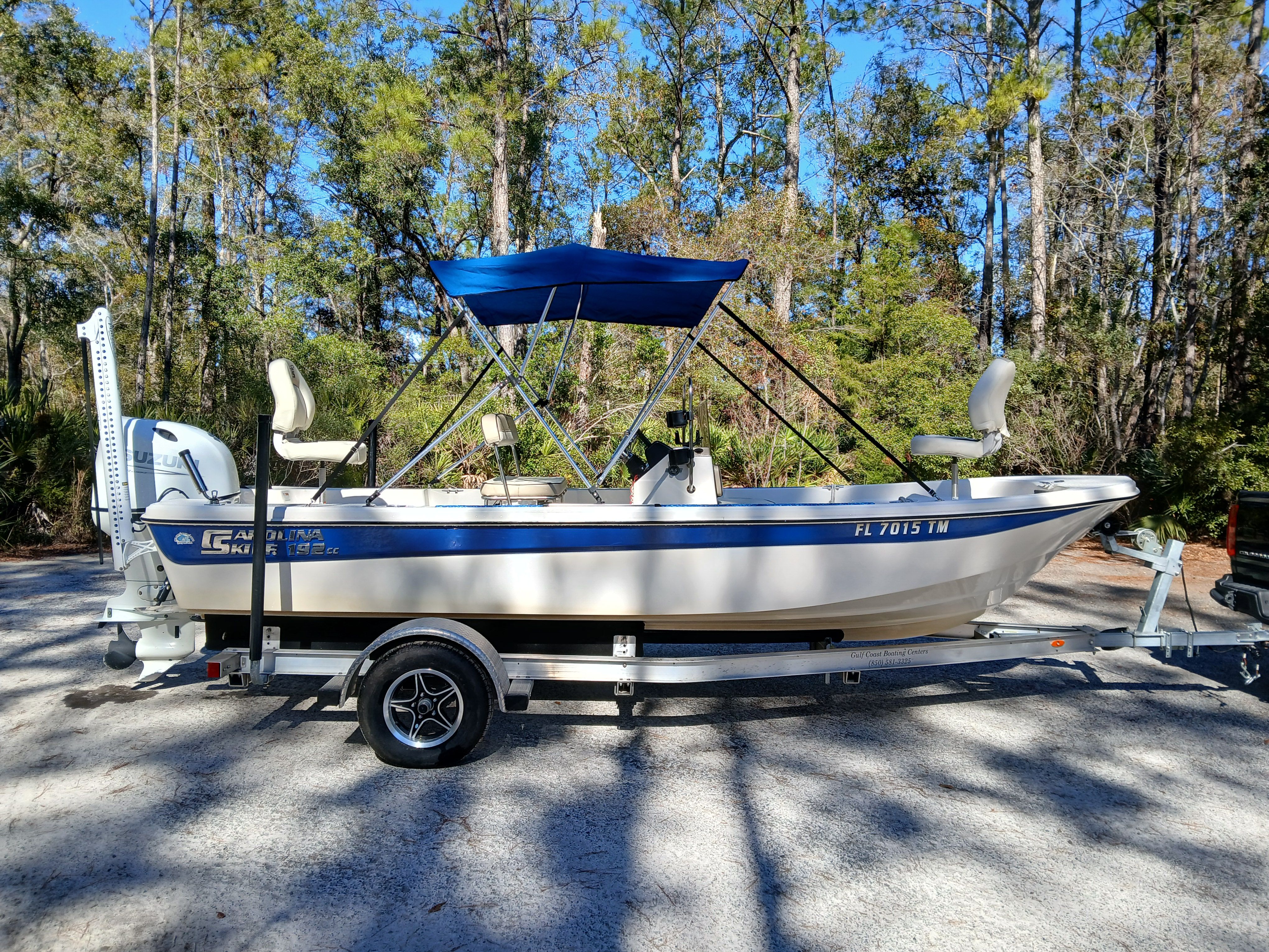2023 Carolina Skiff 192 JLS boat on trailer in forest setting.