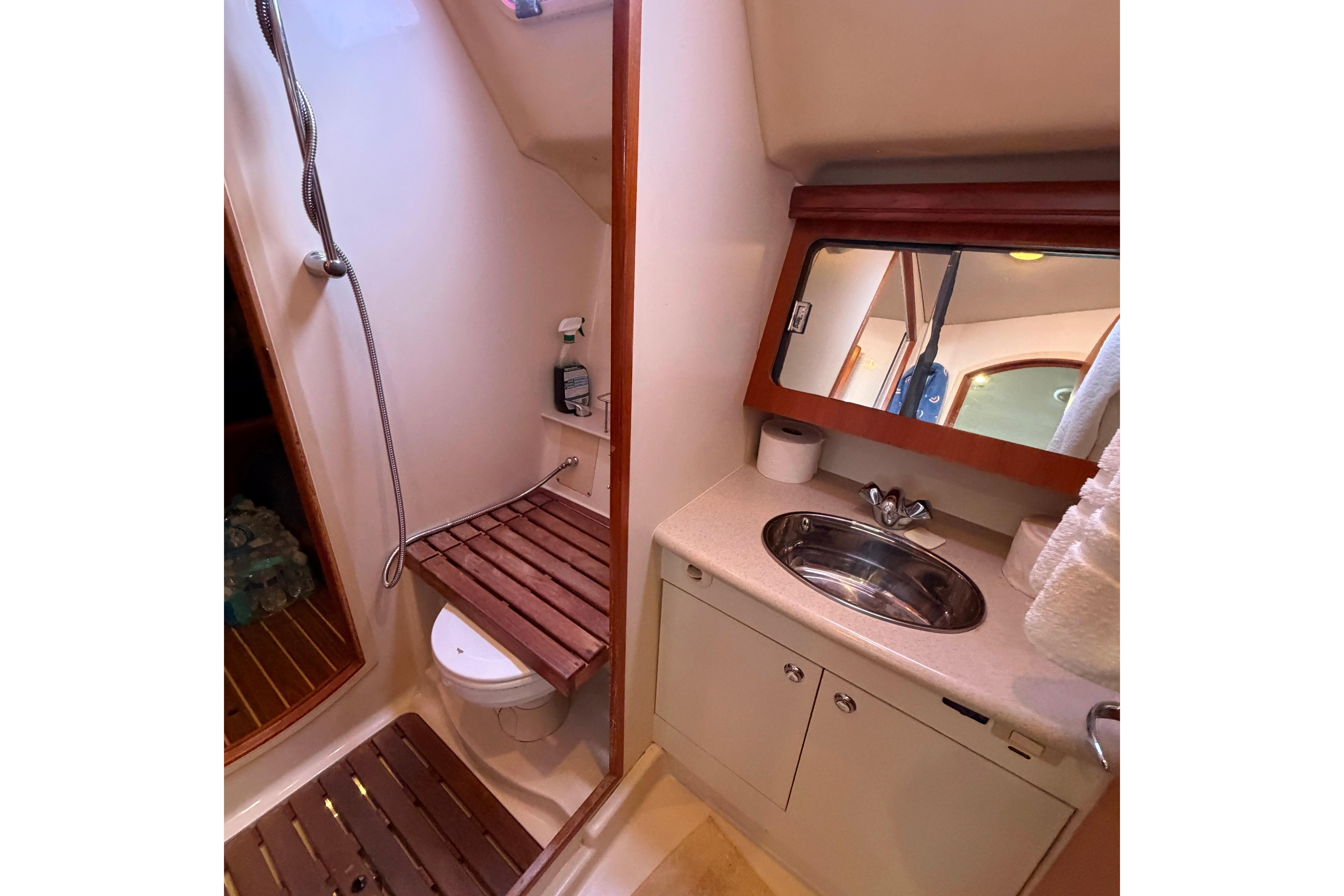 Bathroom interior of 2005 Hunter 38 yacht with shower, toilet, and sink.
