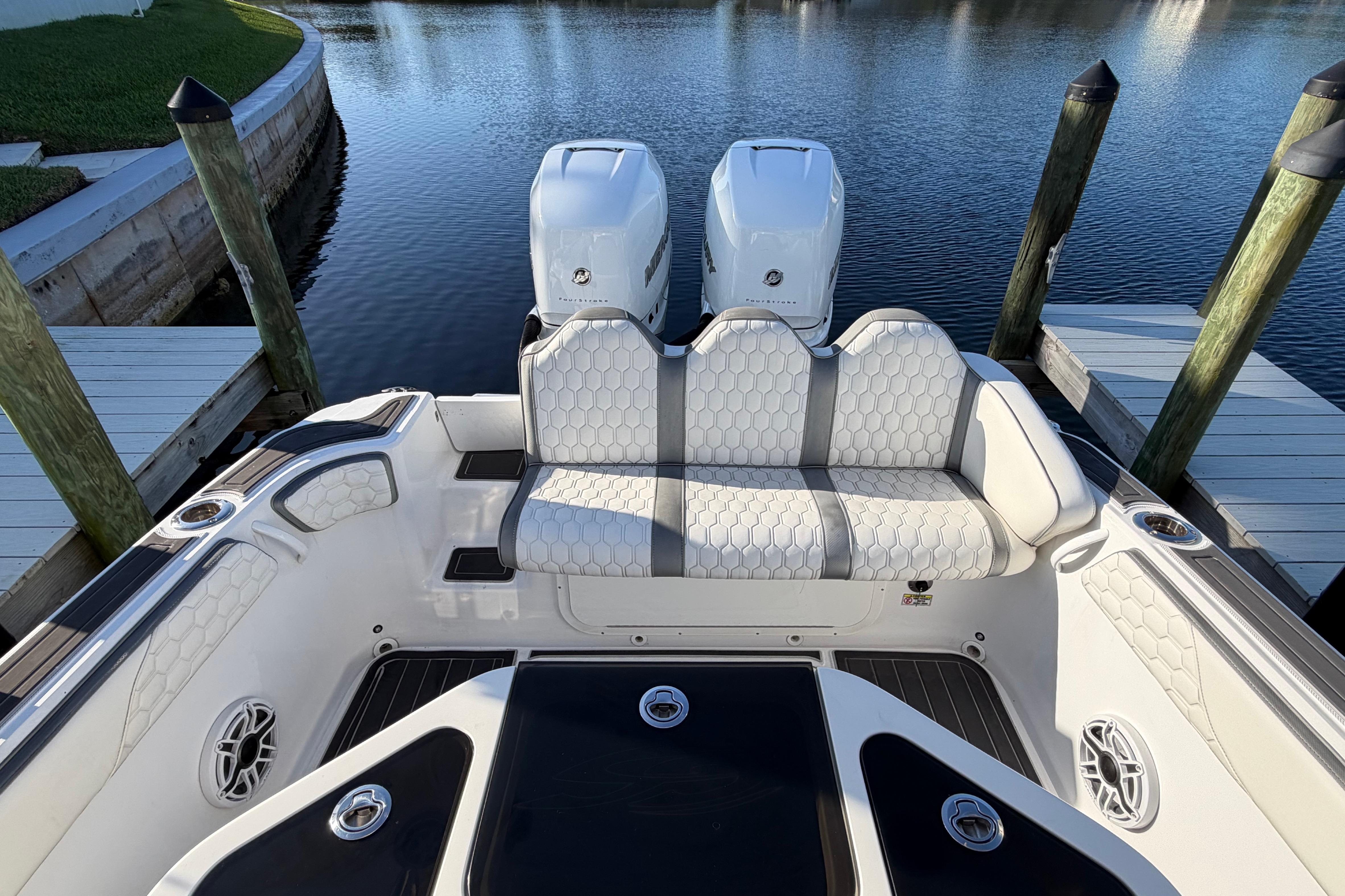 2022 Glasstream 328 Pro-XS boat with dual engines, docked on calm water.