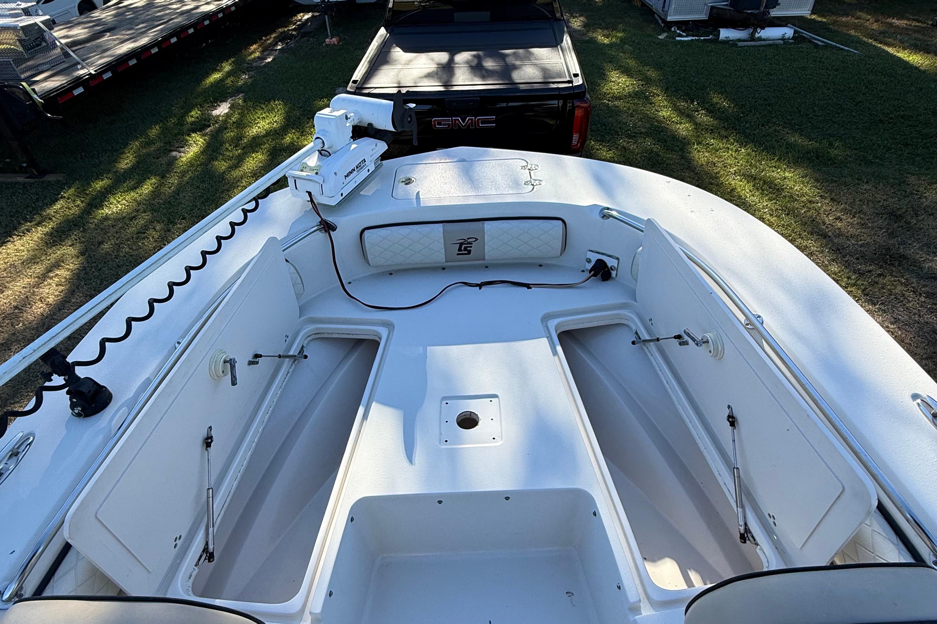 2021 Carolina Skiff 26 Ultra Elite boat deck with open storage compartments.