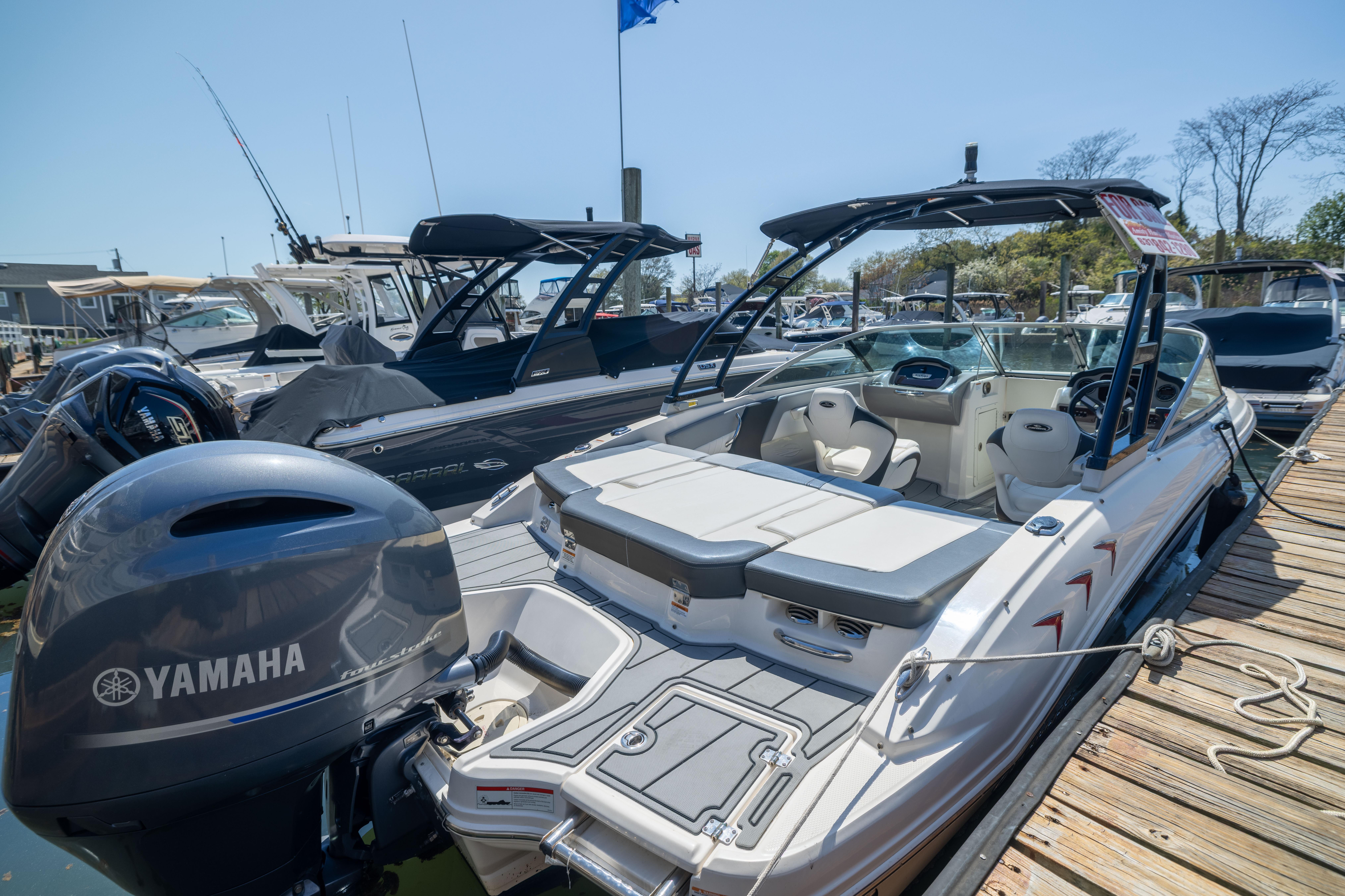 2022 Chaparral 21 SSi OB boat with Yamaha engine docked at marina.
