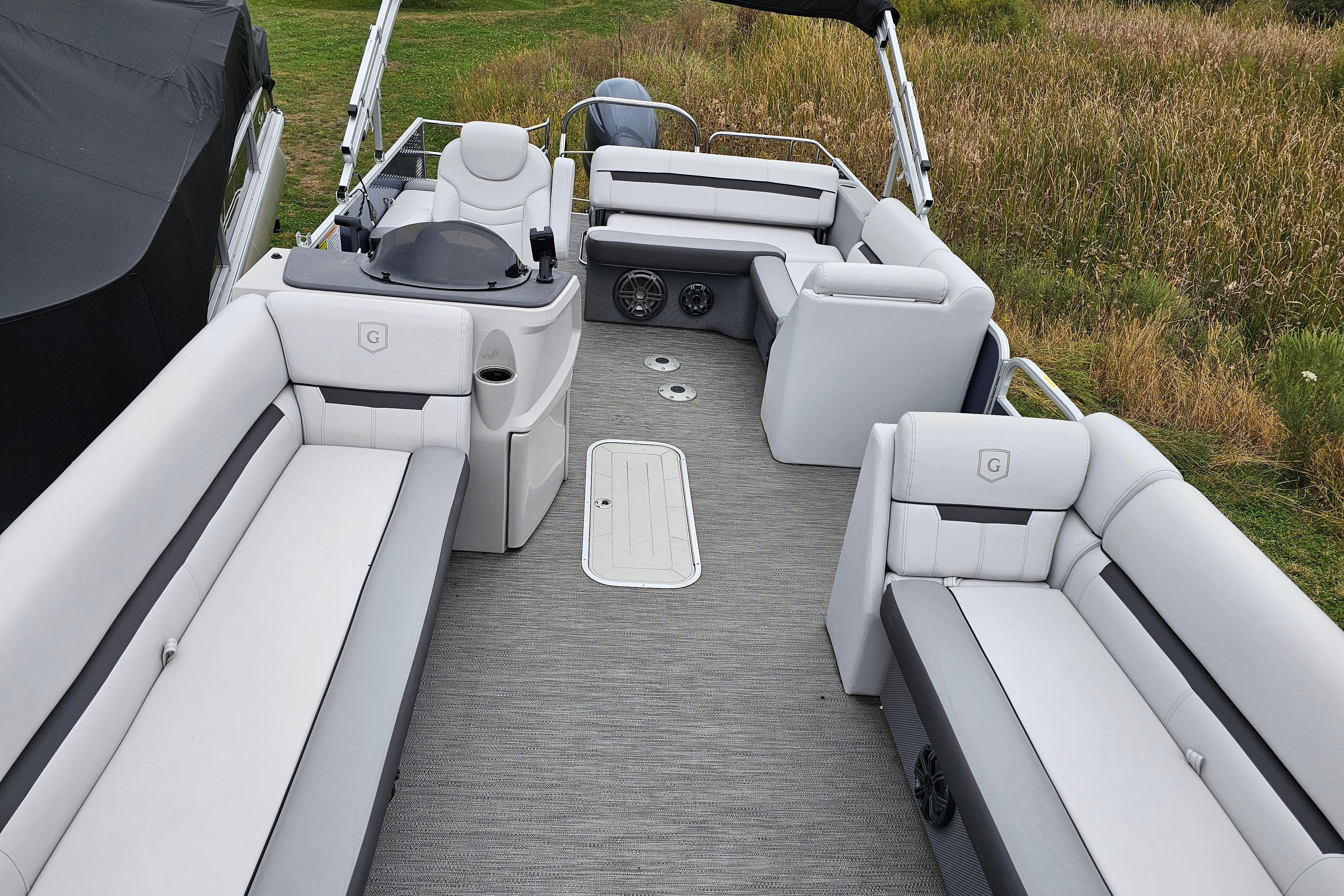 2022 Sweetwater 2286 SFL pontoon boat interior with plush seating and helm.