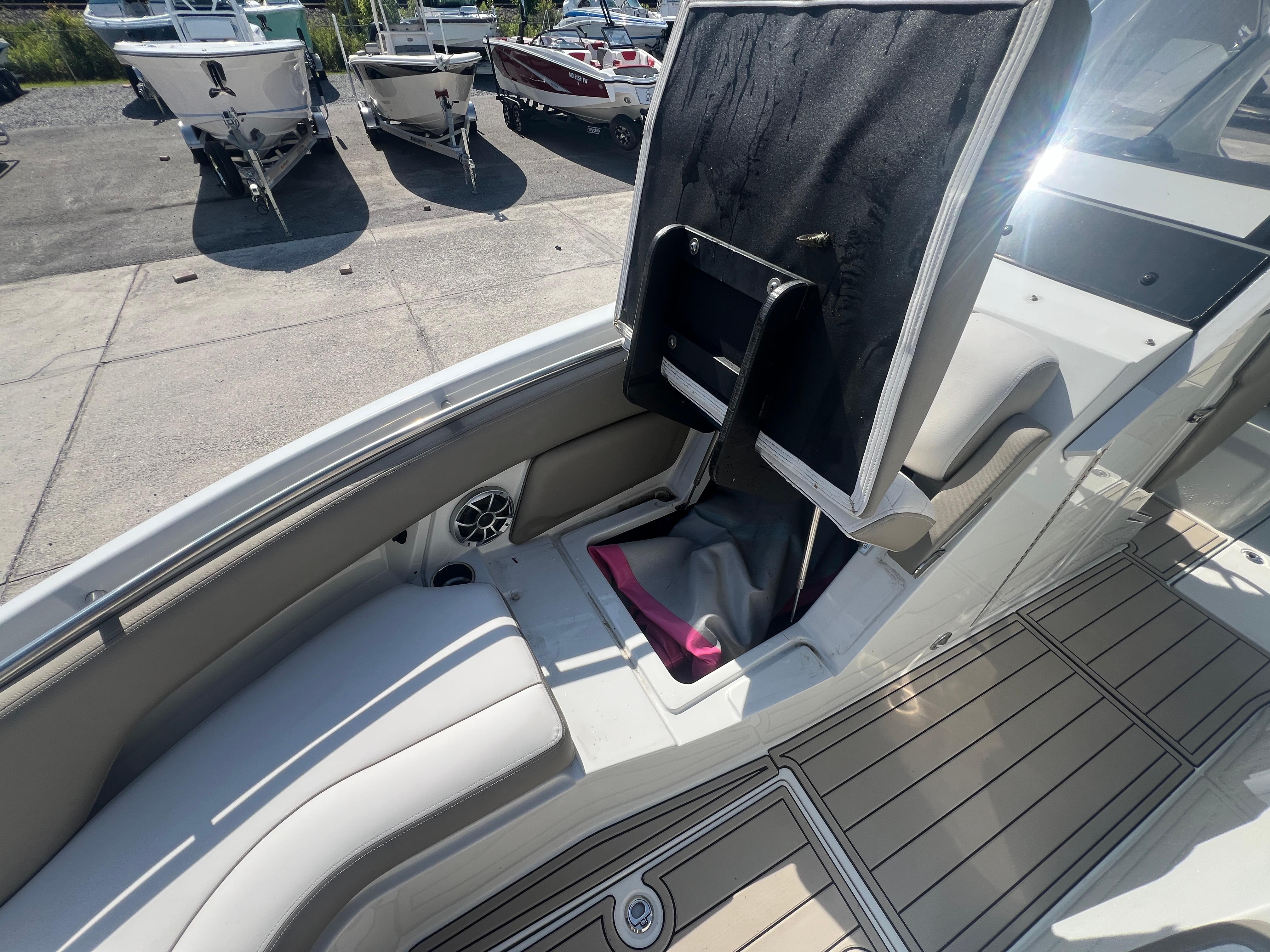 2023 Finseeker 280 DC boat interior with seating and storage compartment.