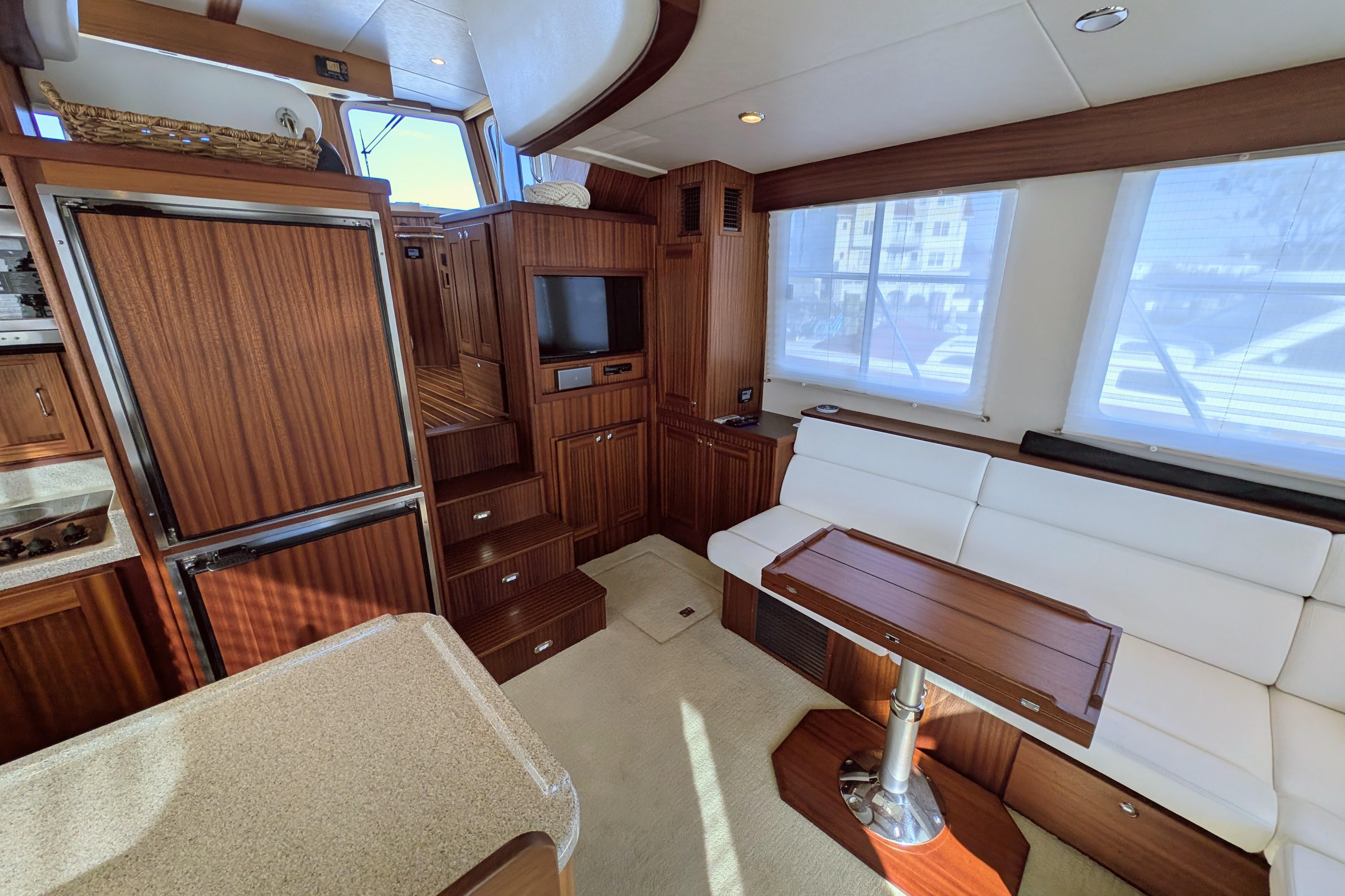Luxurious interior of 2015 American Tug 435 with wood finishes and comfortable seating.