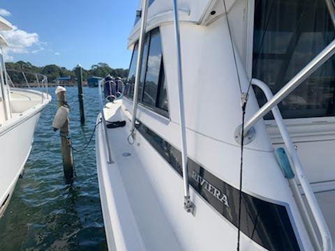 2000 Riviera 34 Convertible yacht docked at a marina.