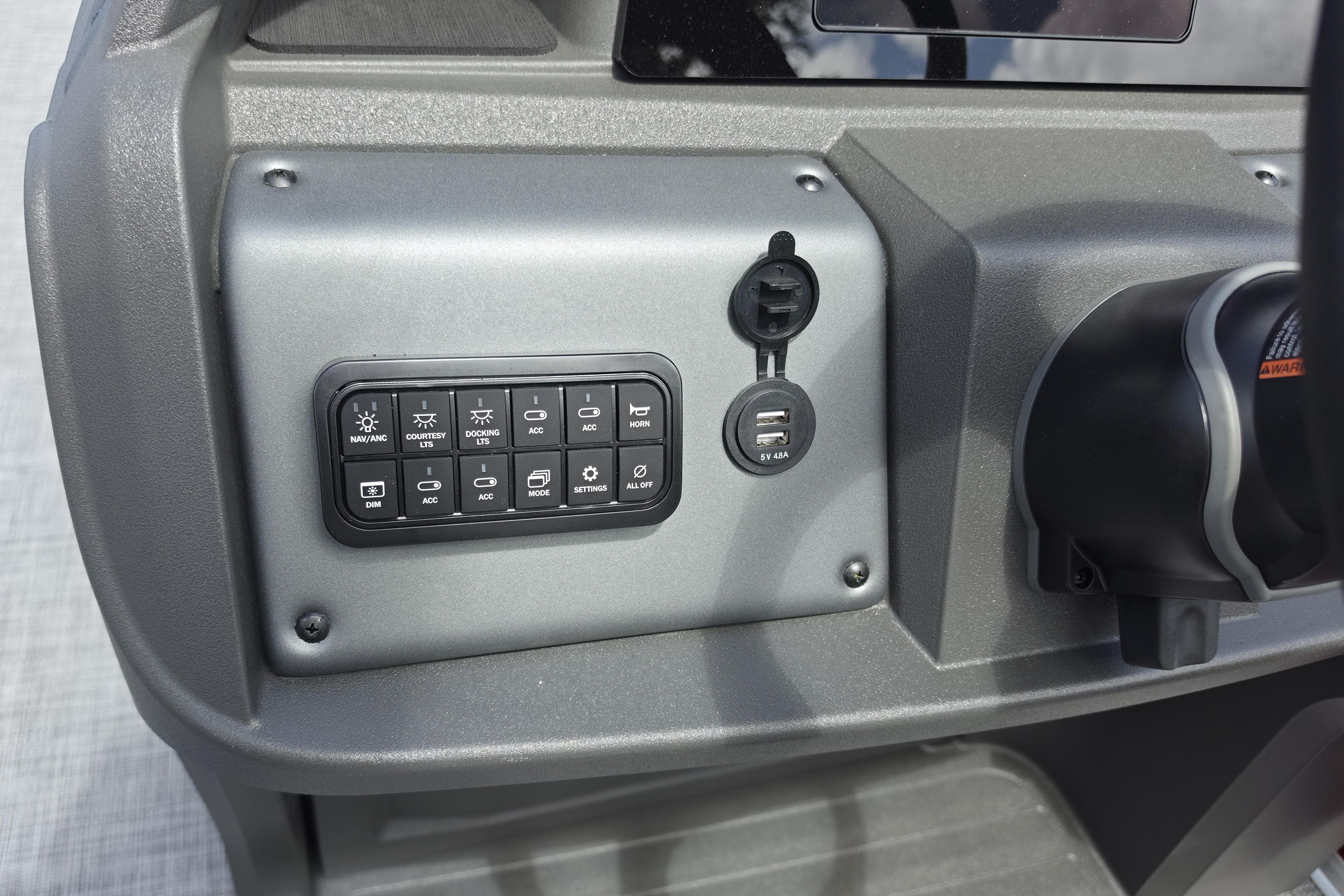 Control panel of 2026 Sun Tracker Party Barge 18 DLX with USB ports and switches.