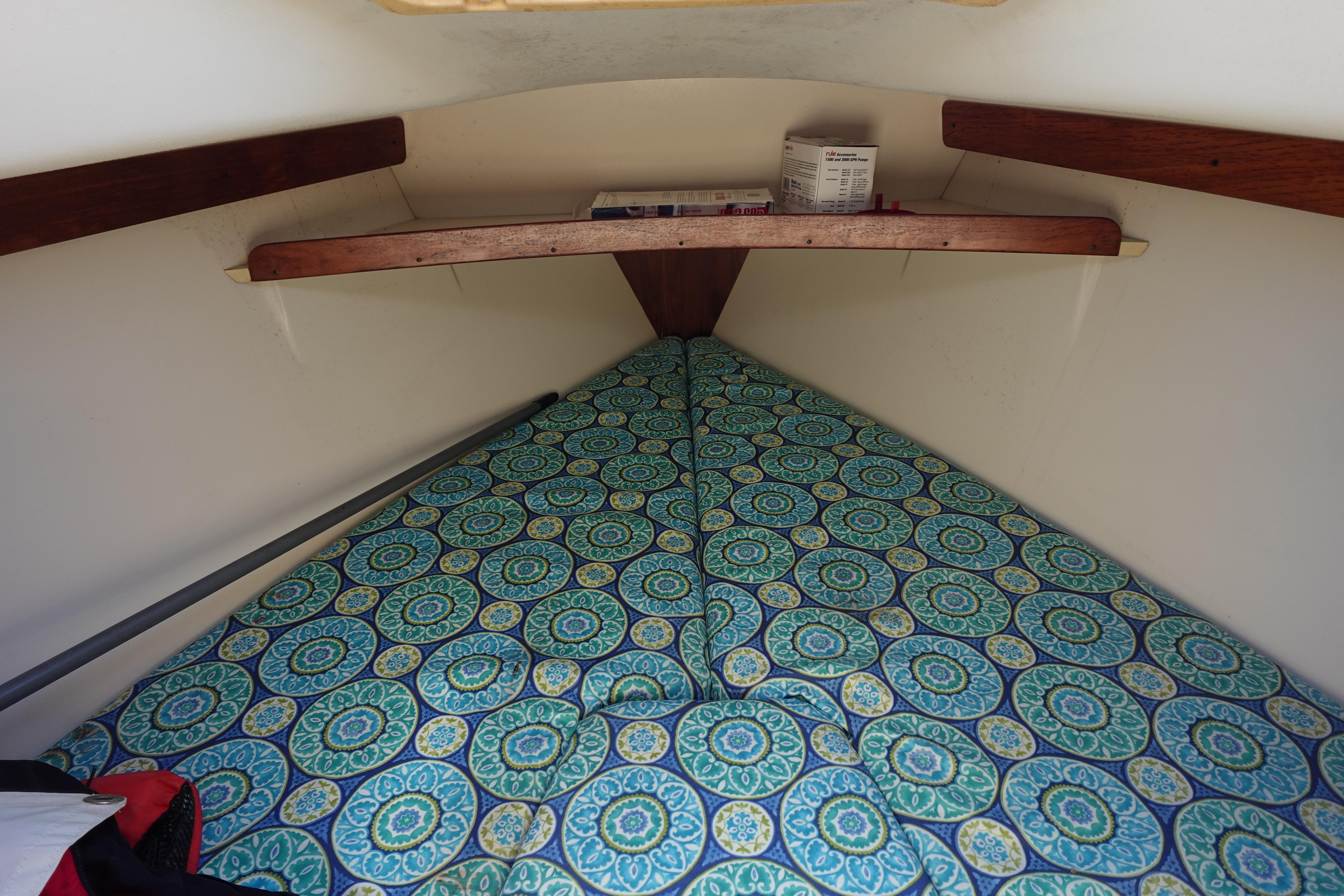 Cozy cabin interior of 1997 Catalina 28 sailboat with patterned bedding.