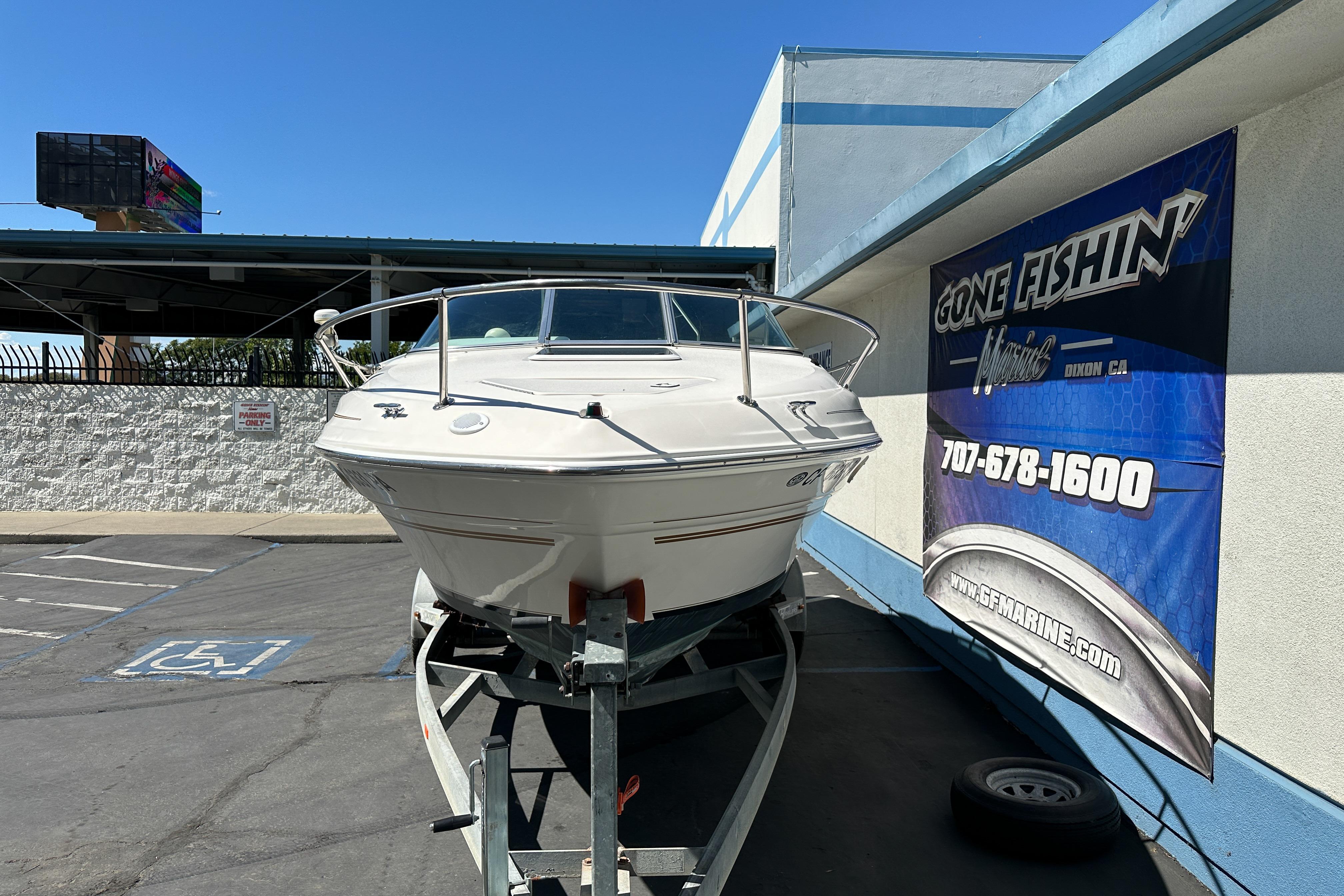 1998 Sea Ray 215 Express Cruiser on trailer at Gone Fishin' Marine dealership.