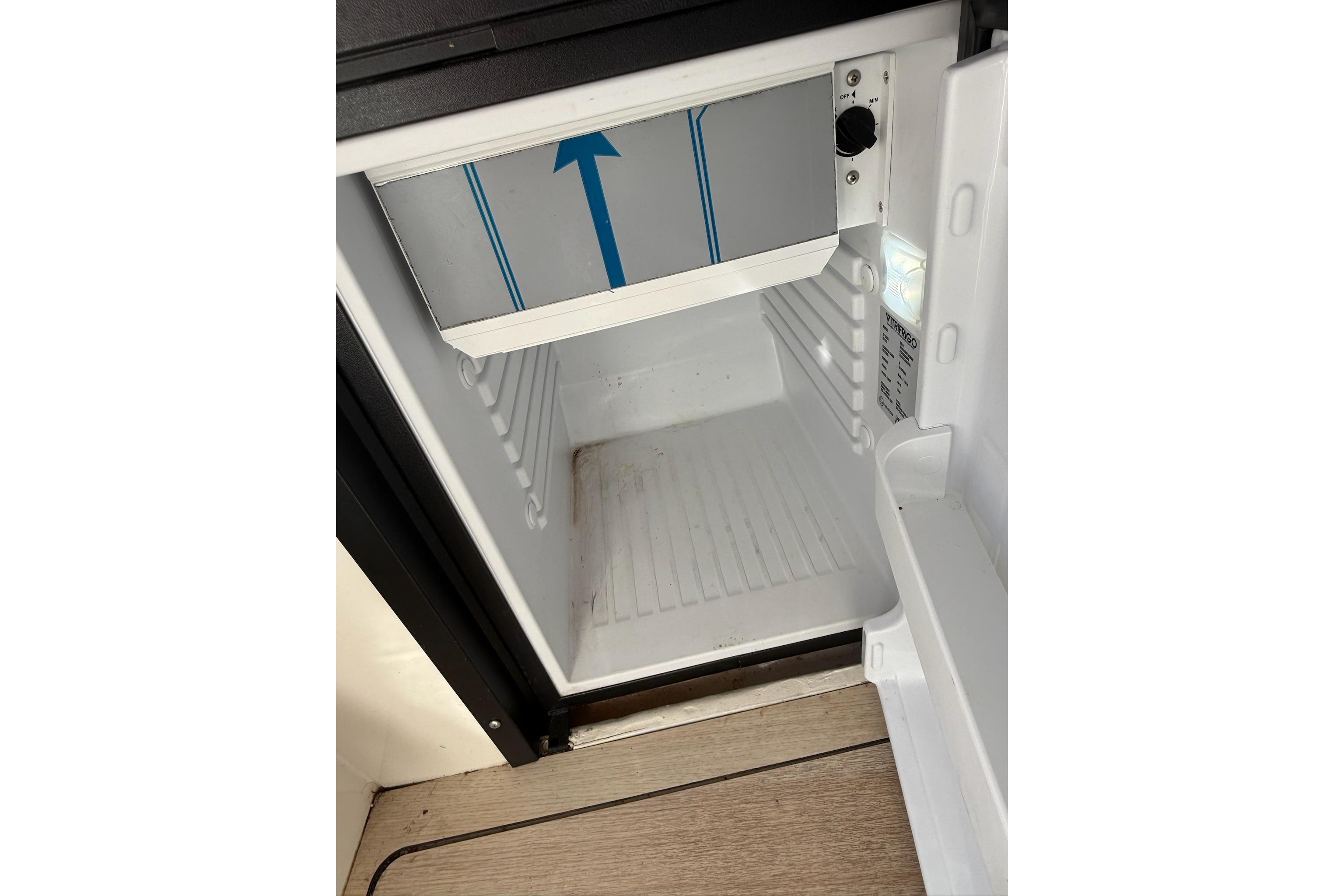 2024 Bayliner Trophy T25 Pilothouse refrigerator interior, open and empty.