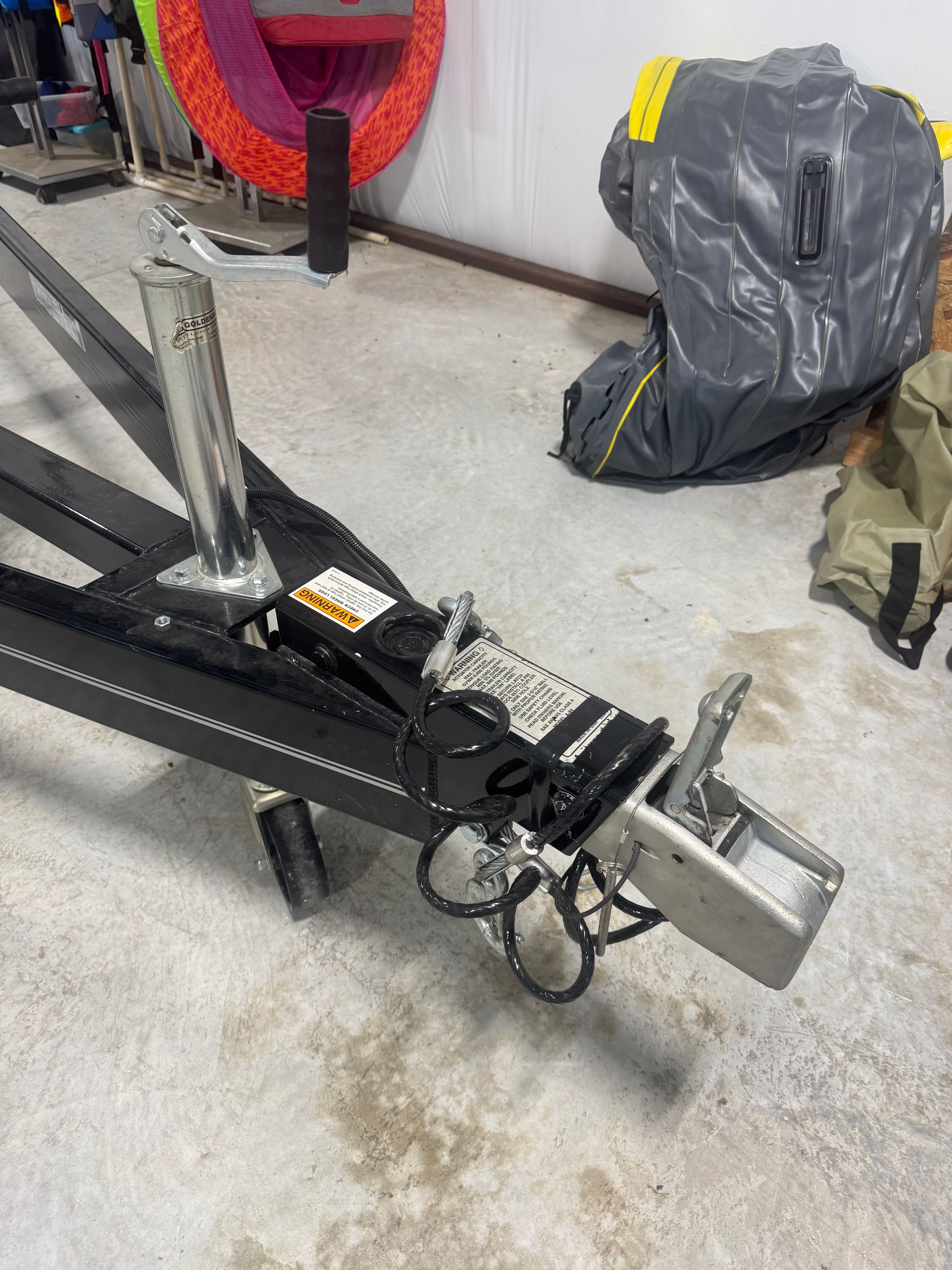 Close-up of a boat trailer with safety chains and hitch.