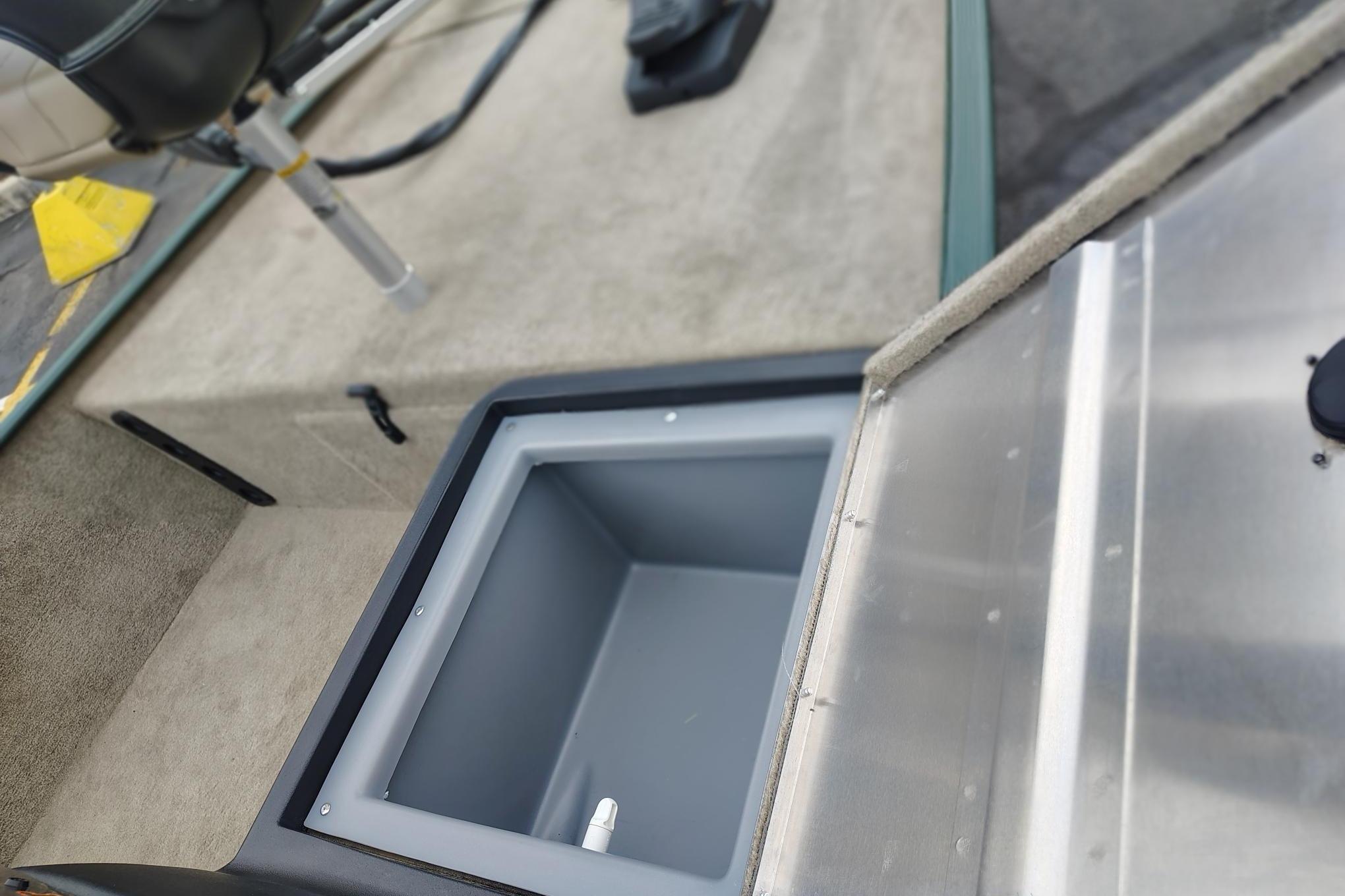 Open storage compartment in 2026 Tracker Bass Tracker Classic Limited boat interior.