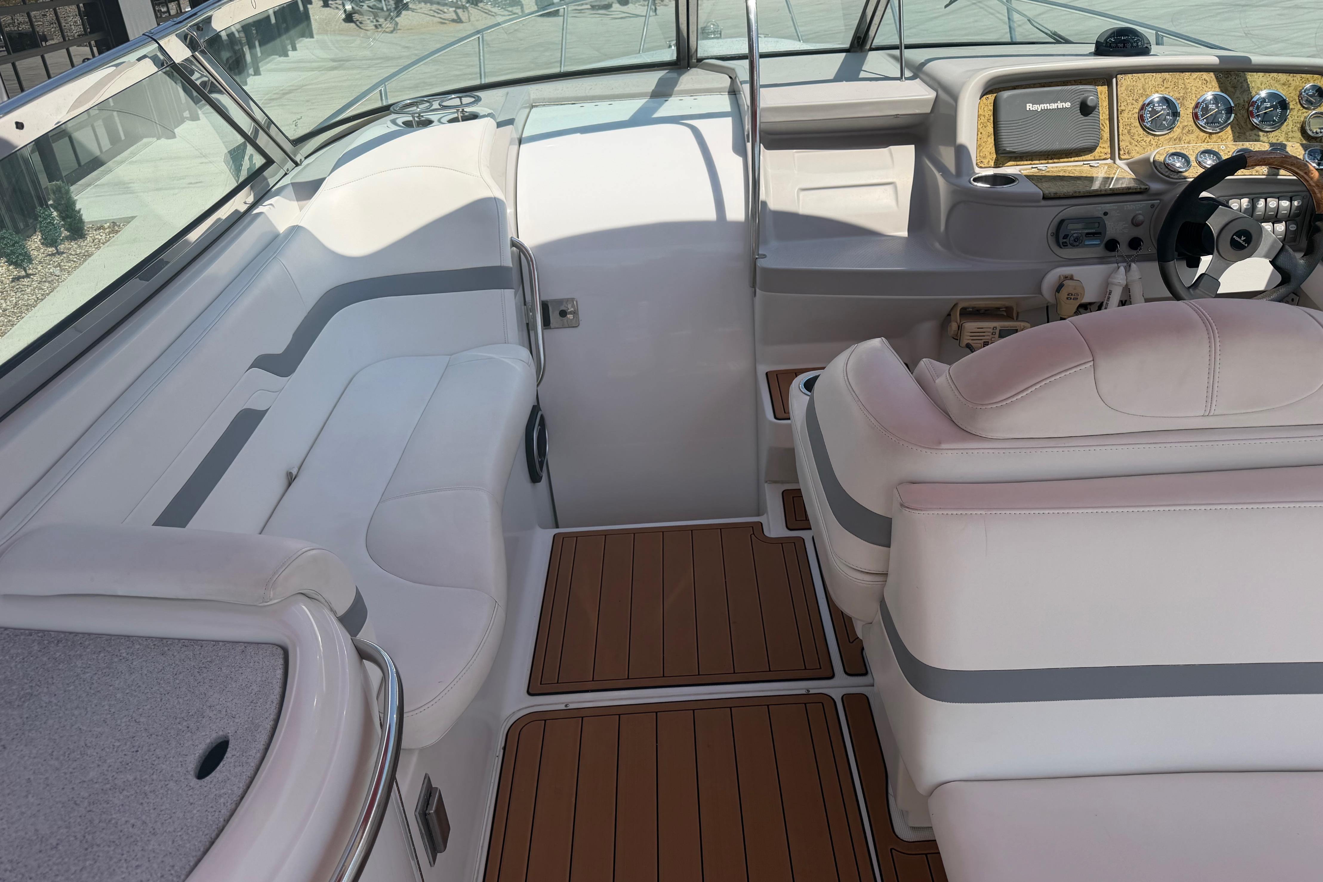 Interior of a 2006 Formula 330 Sun Sport boat with white seating and wood accents.