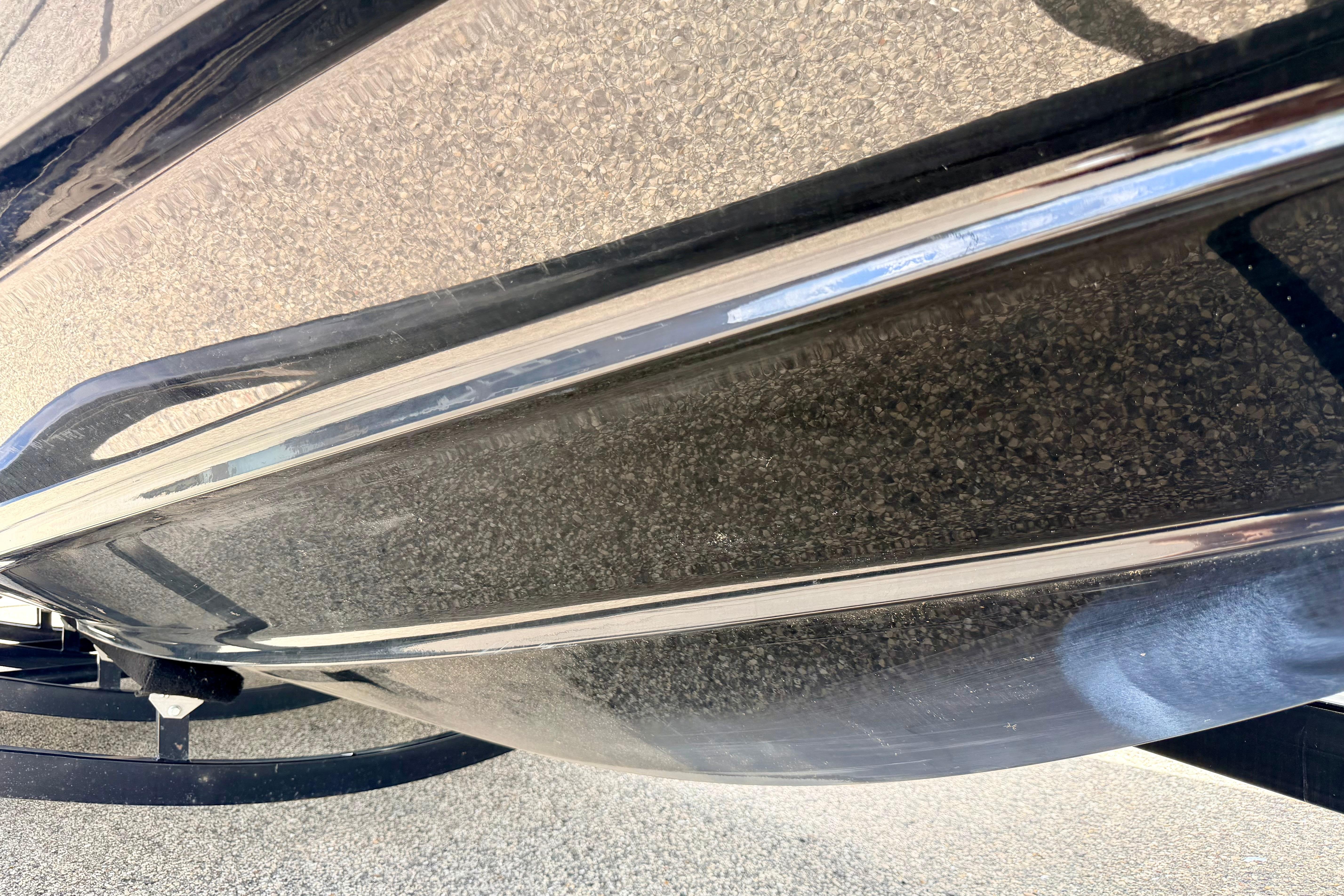 2015 Chaparral Sunesta 264 boat hull, close-up view, showcasing sleek design and finish.