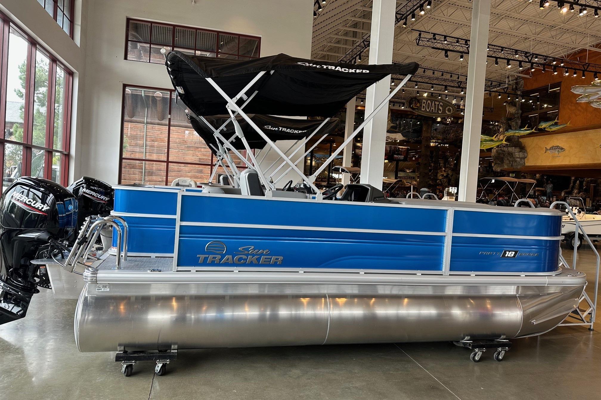 2026 Sun Tracker Party Barge 18 DLX pontoon boat displayed indoors.