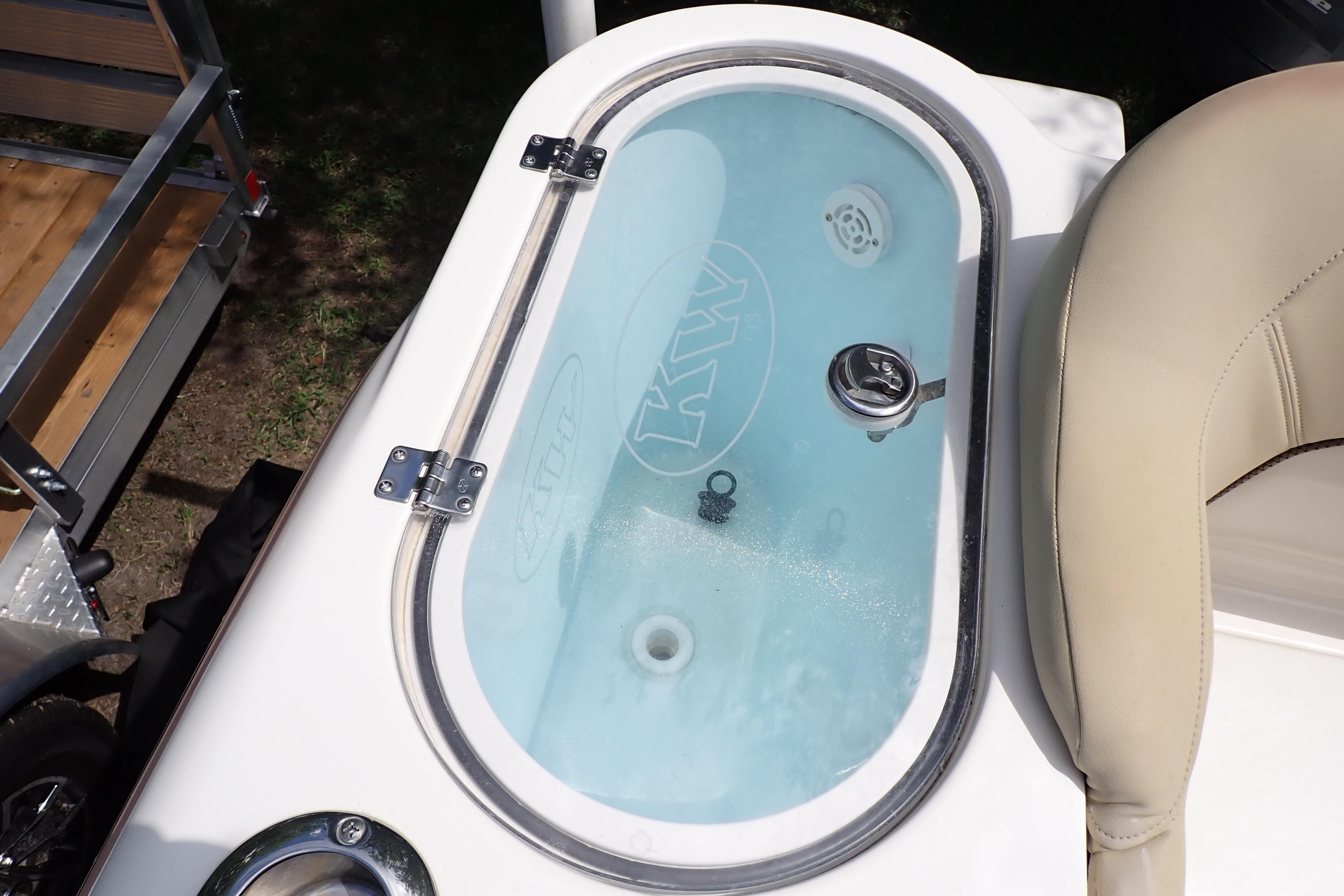 2019 Key West 263 FS boat livewell with clear lid and beige seating.