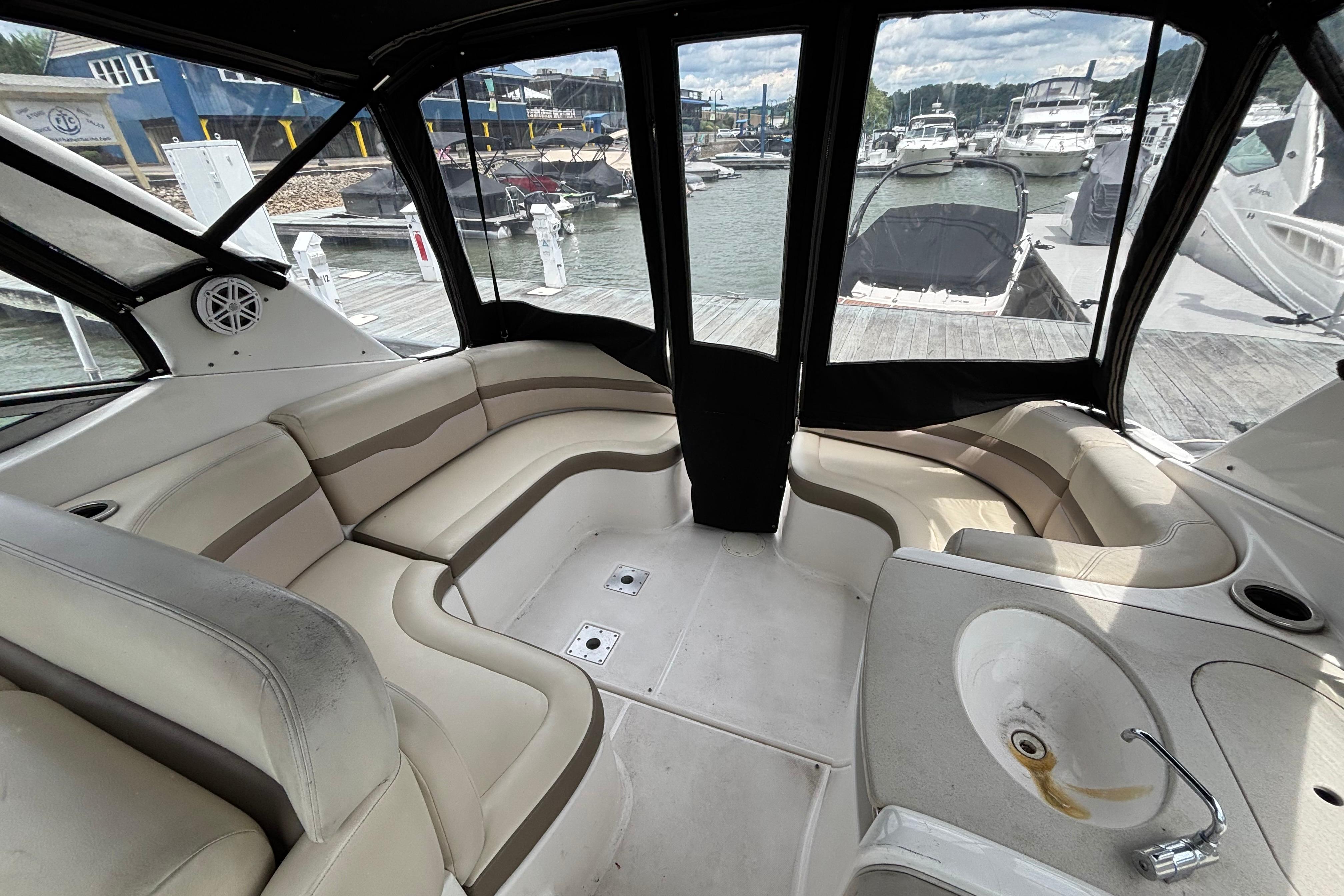 2004 Chaparral Signature 330 boat interior with beige seating and dock view.