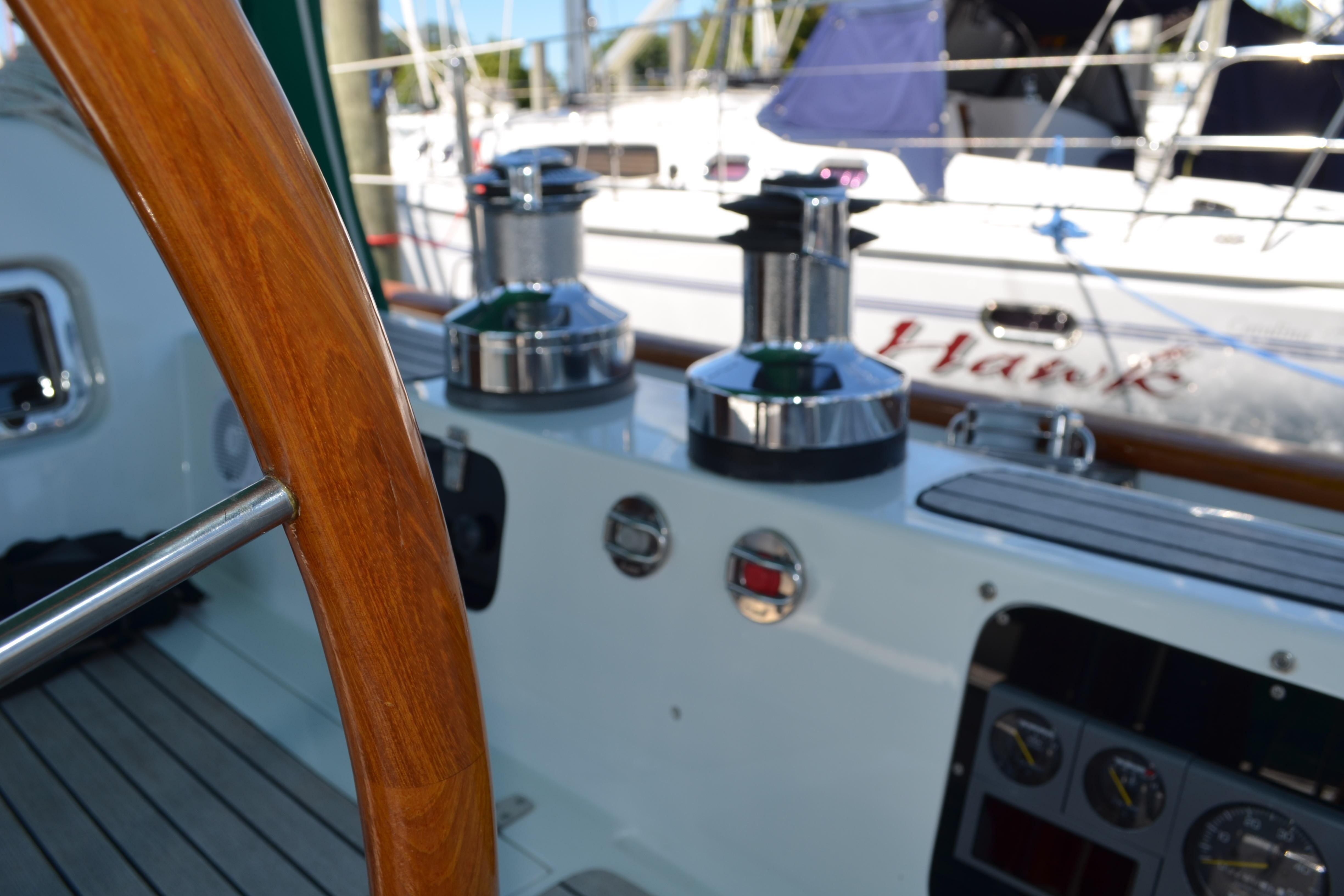 1986 Hans Christian 43 Christina yacht cockpit with wooden wheel and winches.