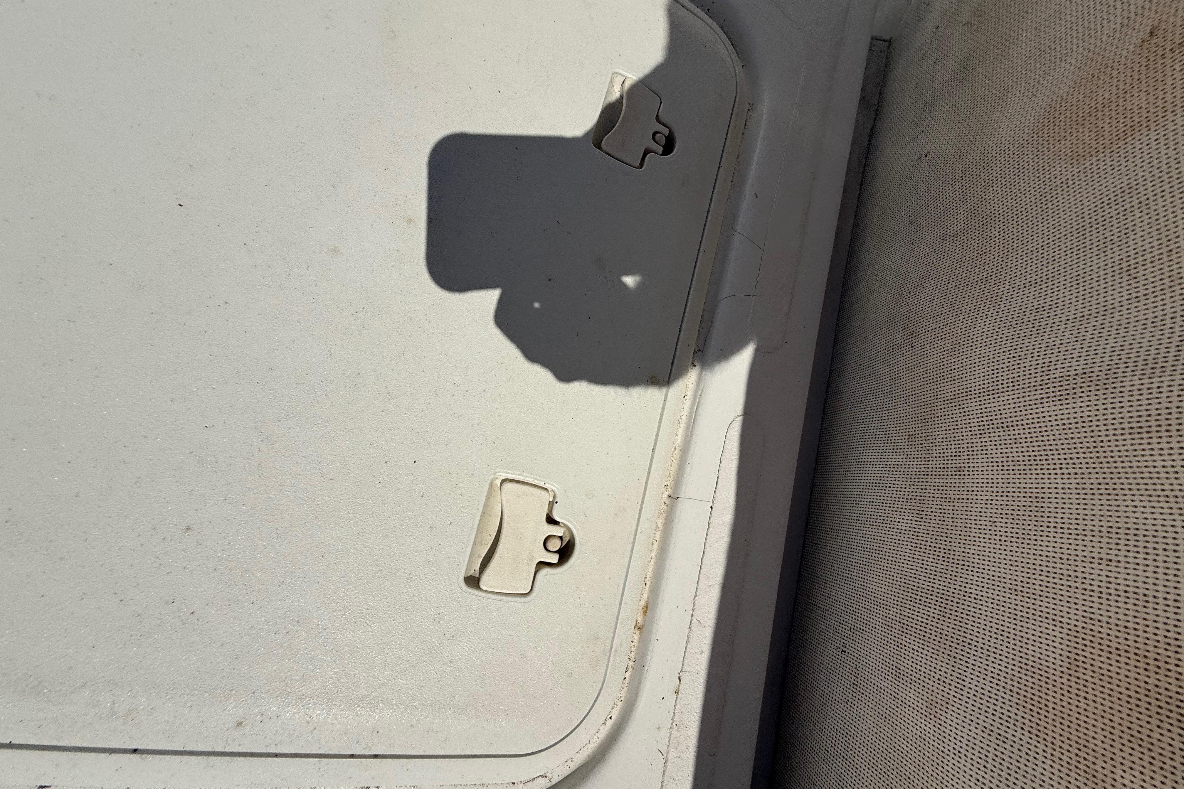 Hatch cover on 2013 Pro-Line 23 Sport boat, featuring latches and textured surface.