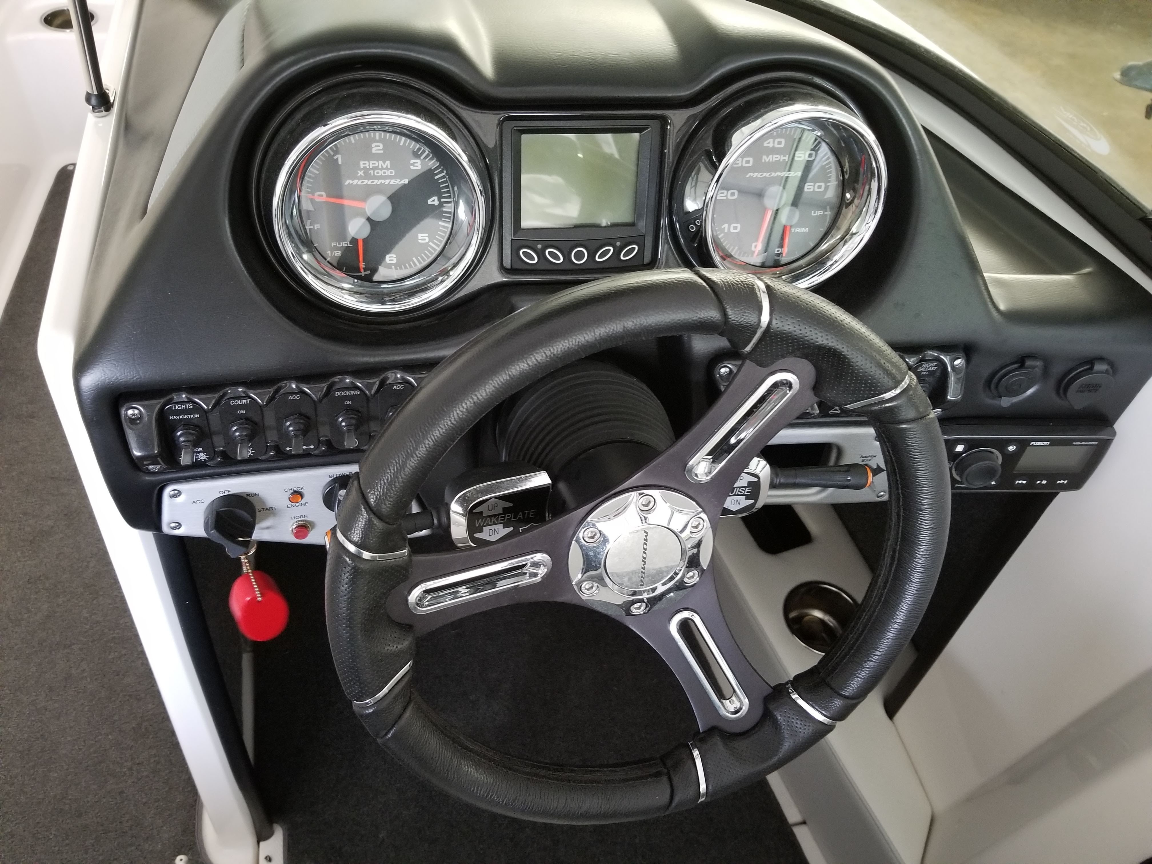 The dashboard of a 2016 Moomba Mondo with steering wheel and gauges.