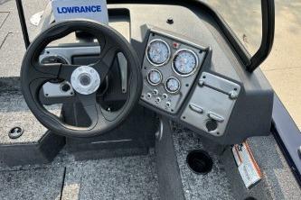 2026 Tracker Pro Guide V-175 WT boat dashboard with steering wheel and instrument panel.