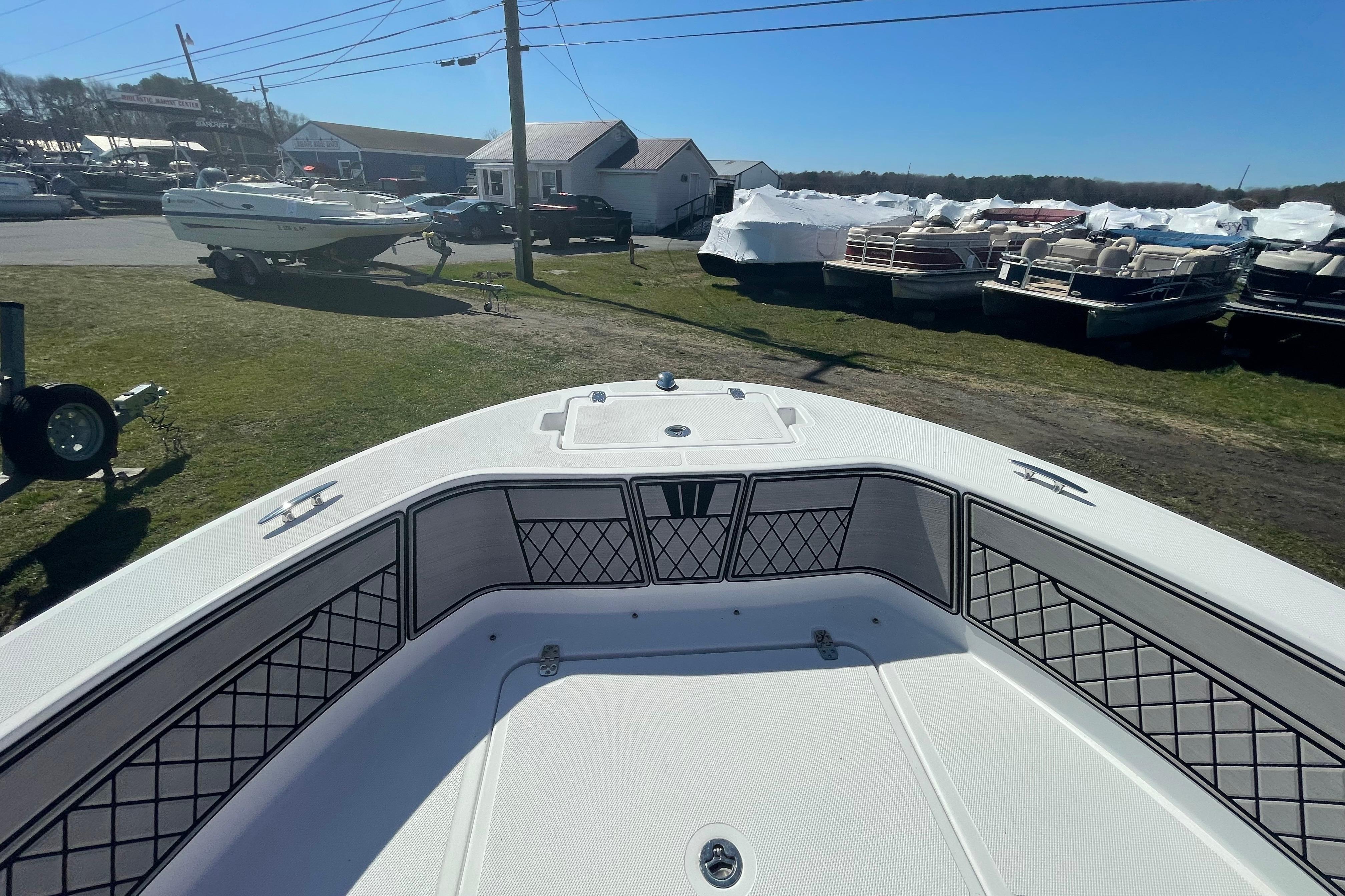 2022 Wellcraft 202 Fisherman boat interior at a marina, surrounded by other boats.