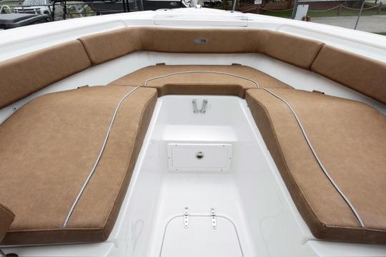 2026 Sea Hunt Ultra 255 SE boat interior with tan cushioned seating.