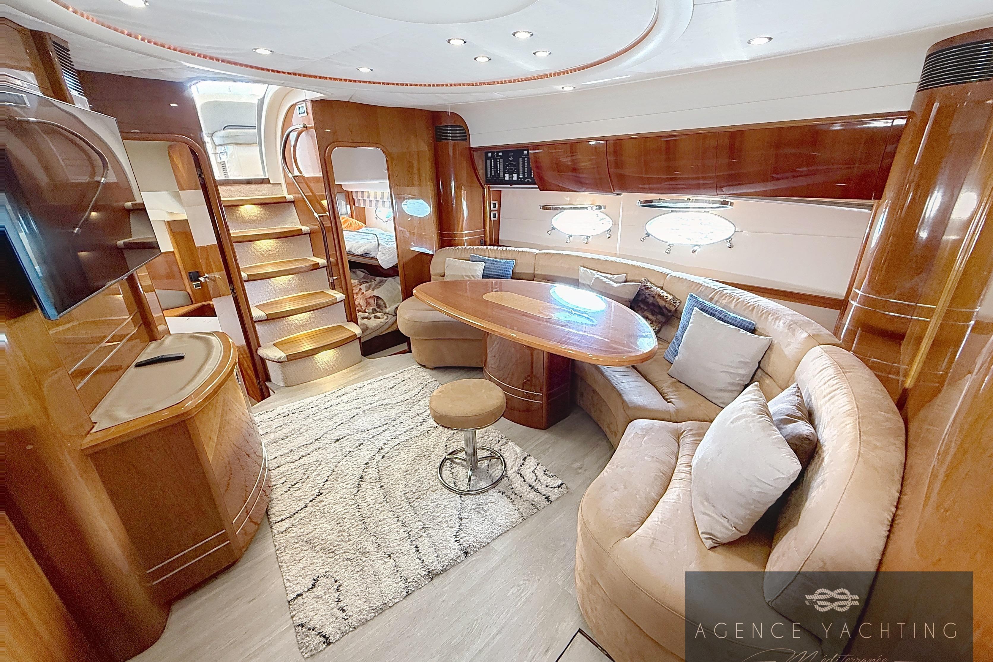 Luxurious interior of 2004 Princess V58 yacht with elegant wood finishes and plush seating.