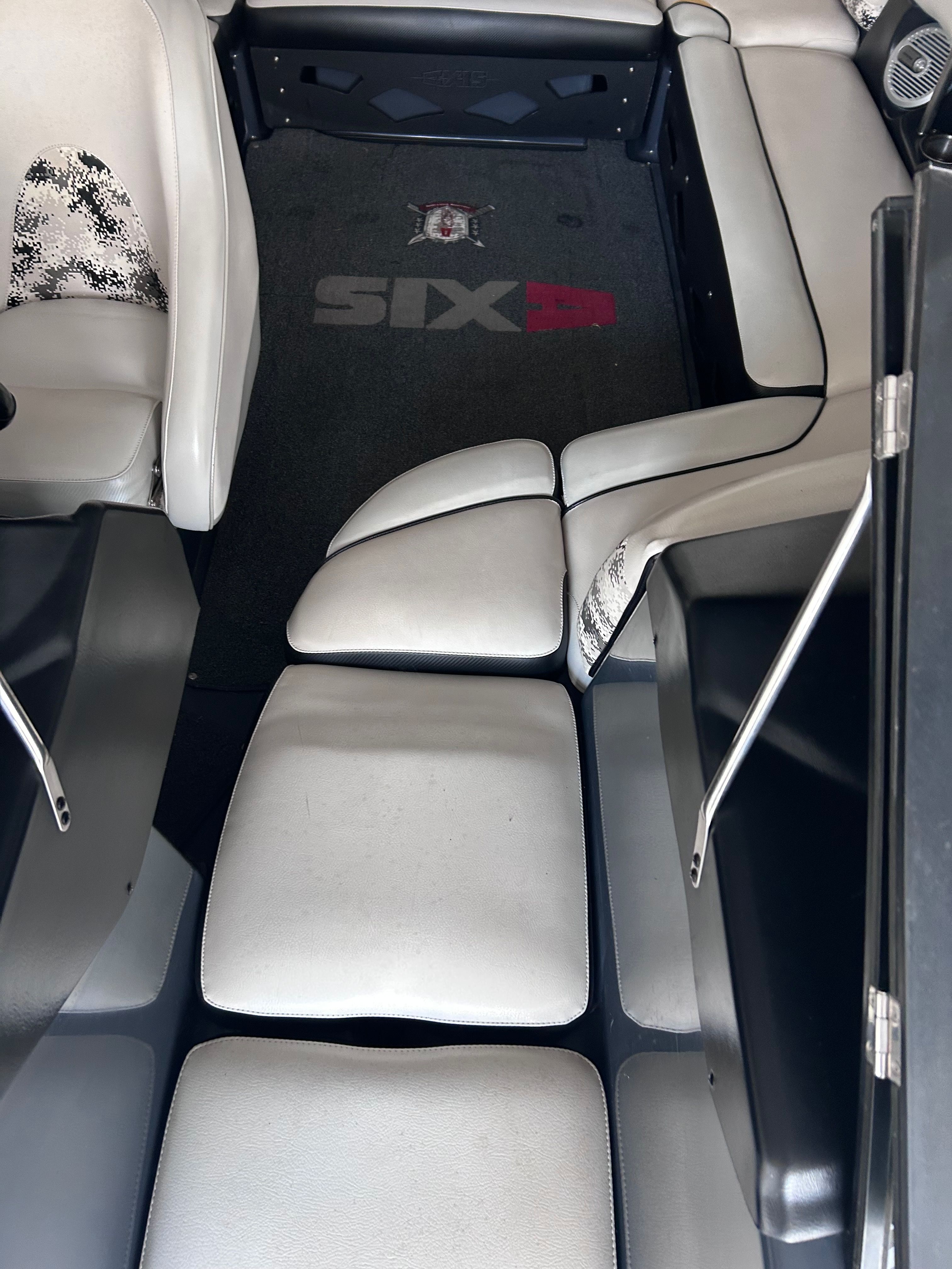 Interior of a 2013 Axis A22 boat with white upholstery.