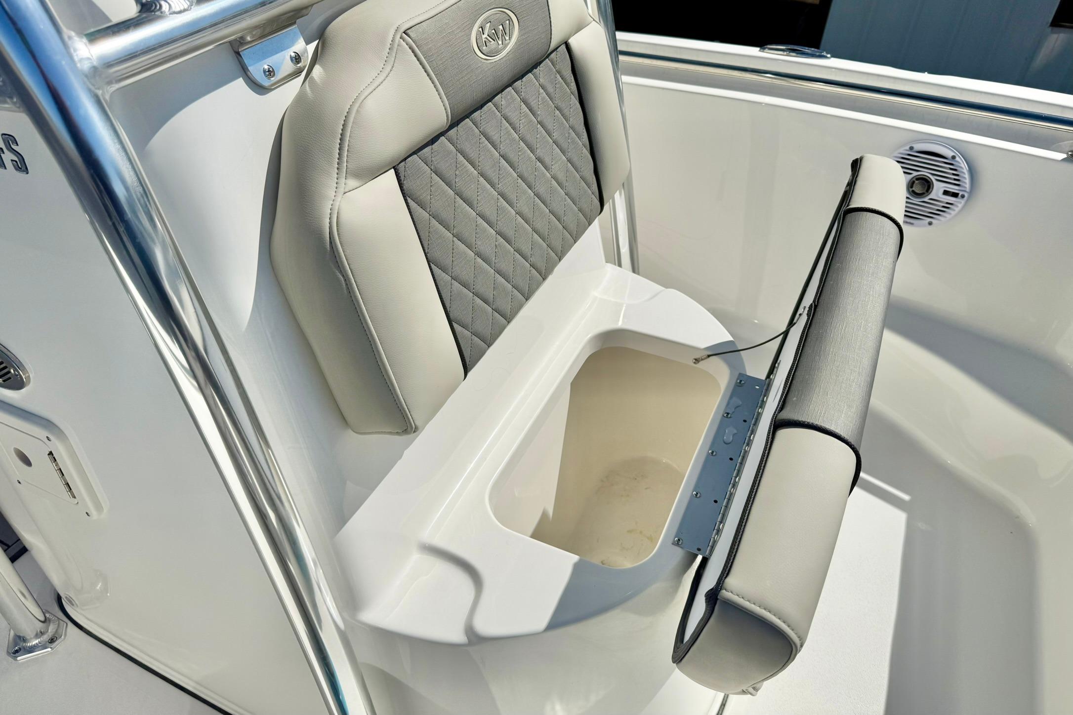 2026 Key West 189 FS boat seat with storage compartment open.