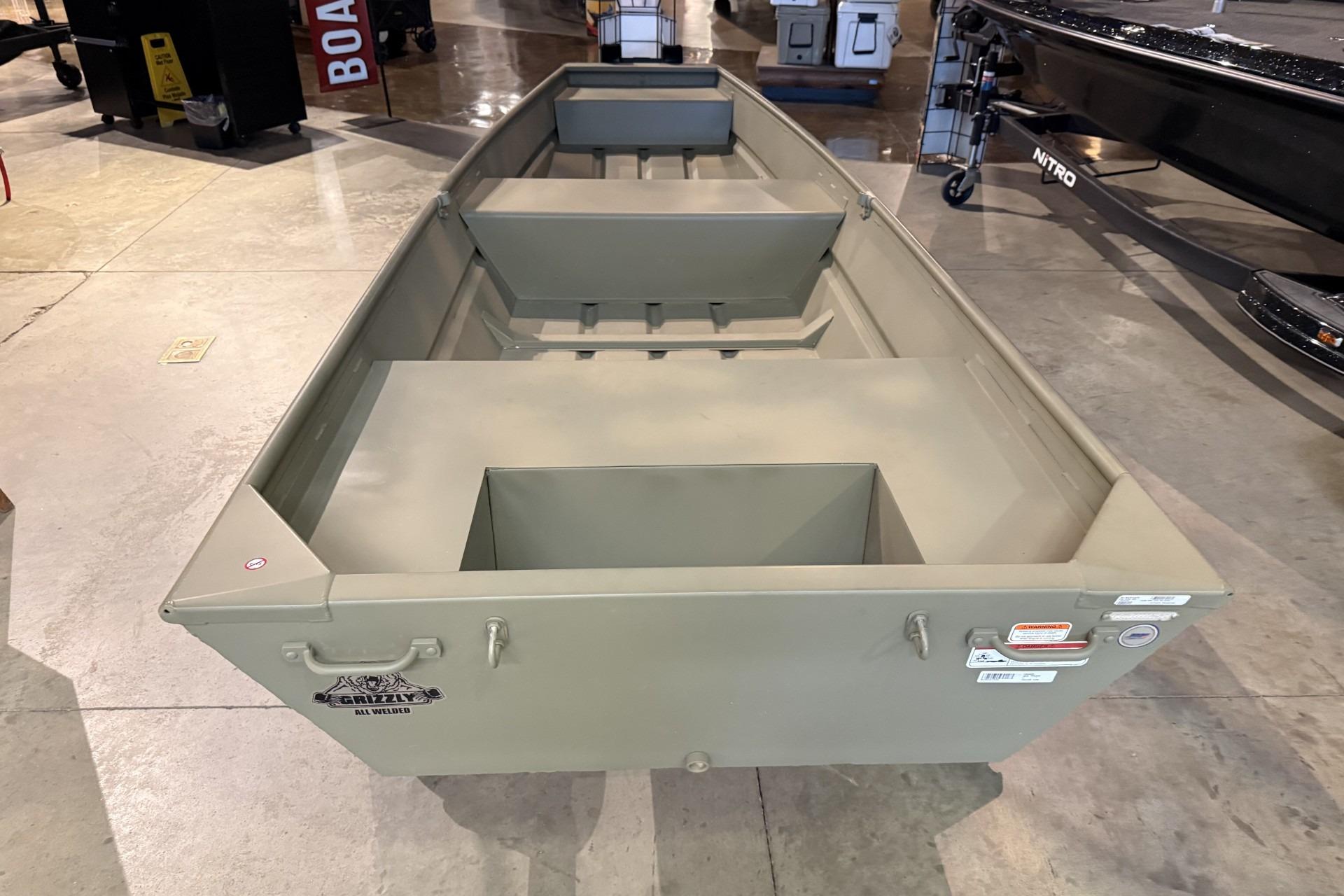 2026 Tracker Grizzly 14 Jon boat displayed in showroom, showcasing its durable design.