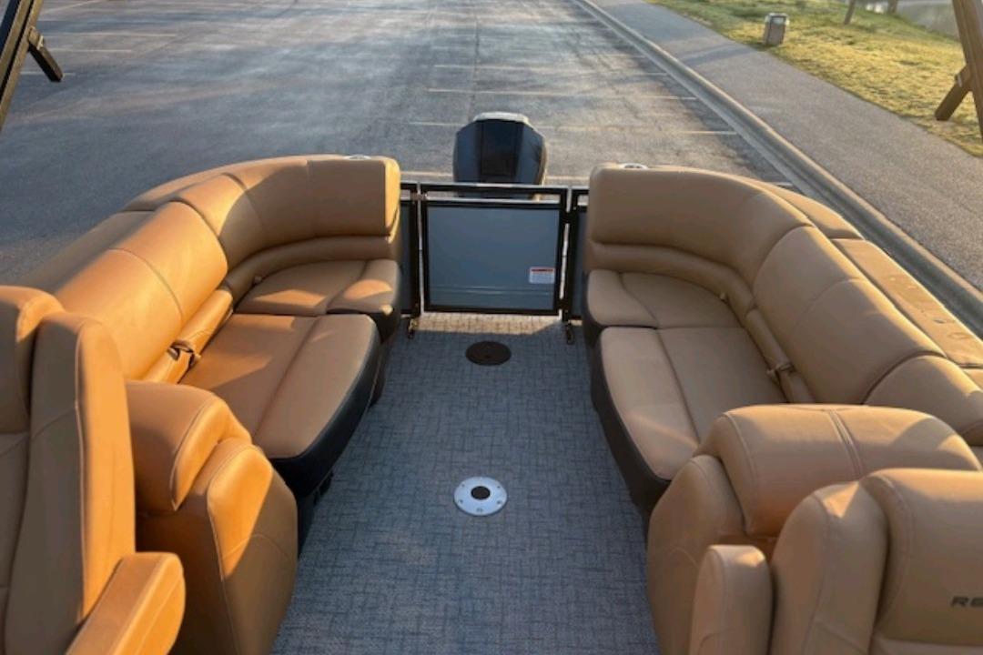 2026 Regency 230 DL pontoon boat with tan seating and spacious interior.