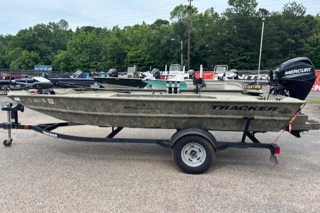 2017 Tracker Grizzly 1654 MVX Sportsman boat on trailer, parked outdoors.