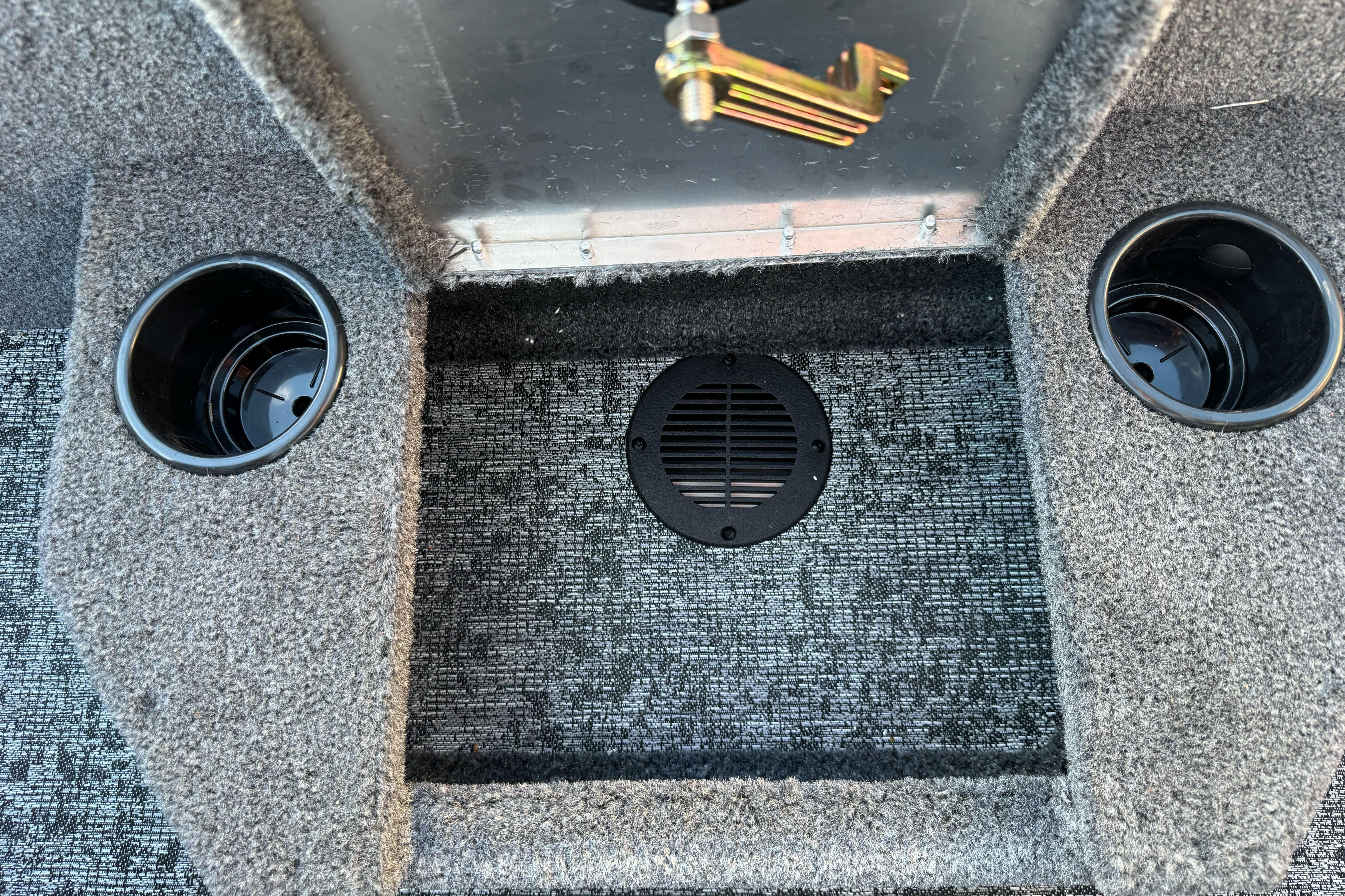 2026 Tracker Targa V-18 WT interior with cup holders and carpeted flooring.