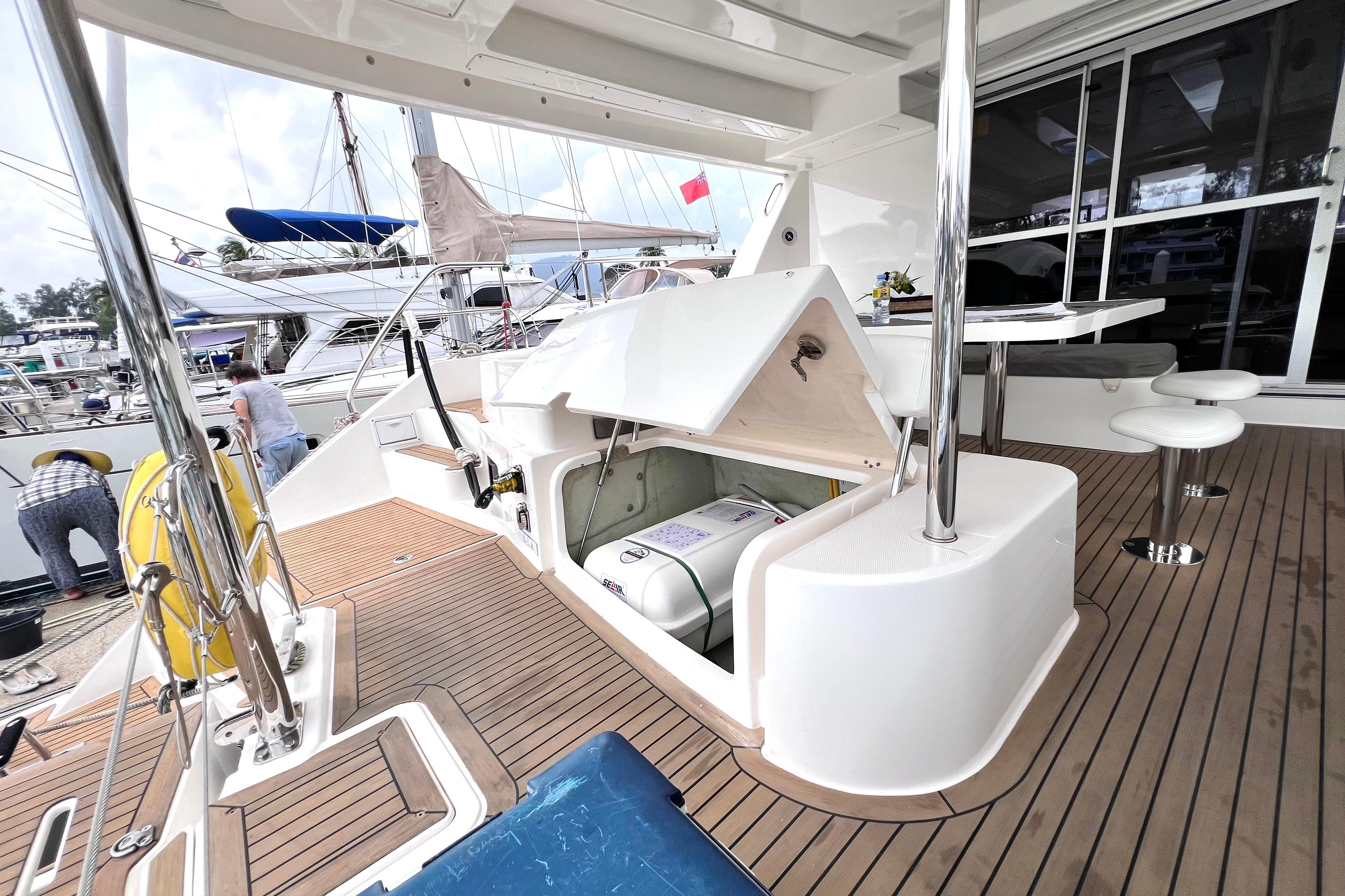 2019 Leopard 51 Powercat yacht deck with open storage compartment and seating area.