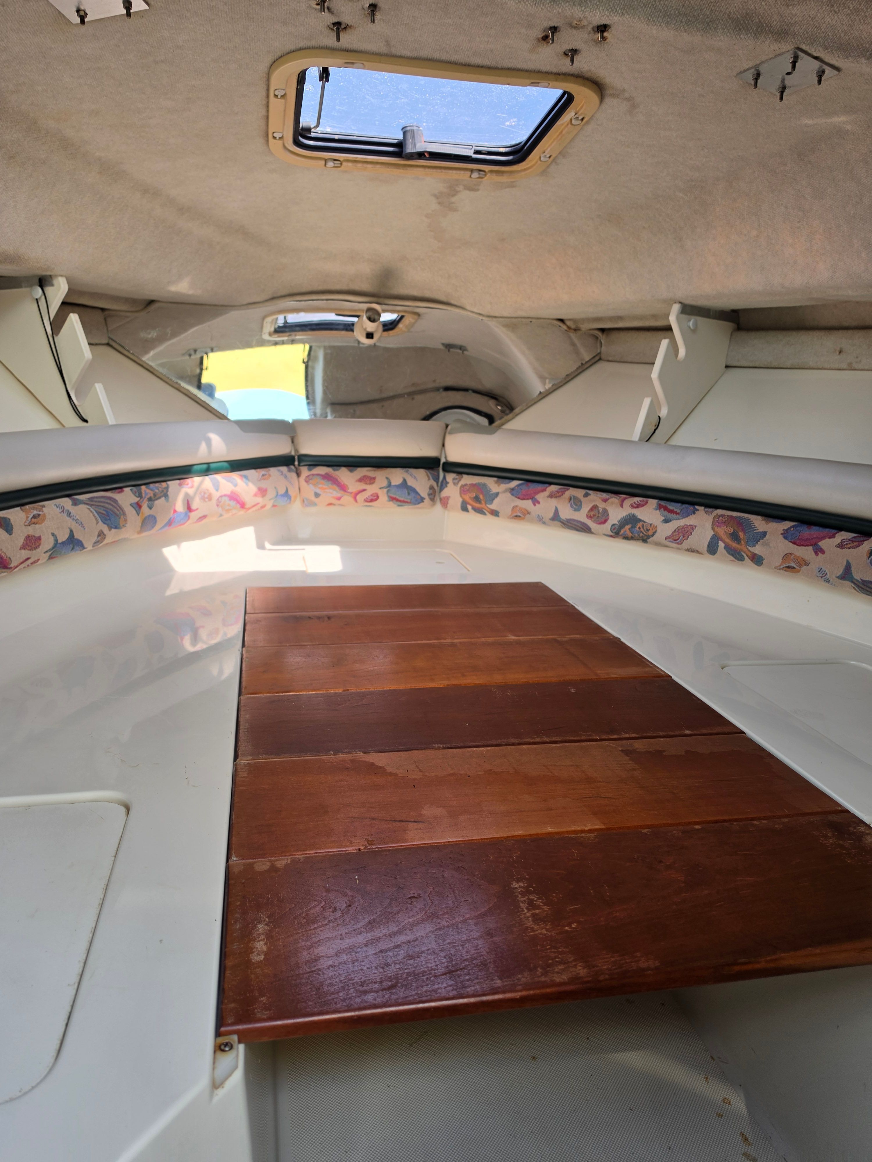 Interior of a 1998 Hydra-Sports 2450 with wooden flooring and a ceiling hatch.