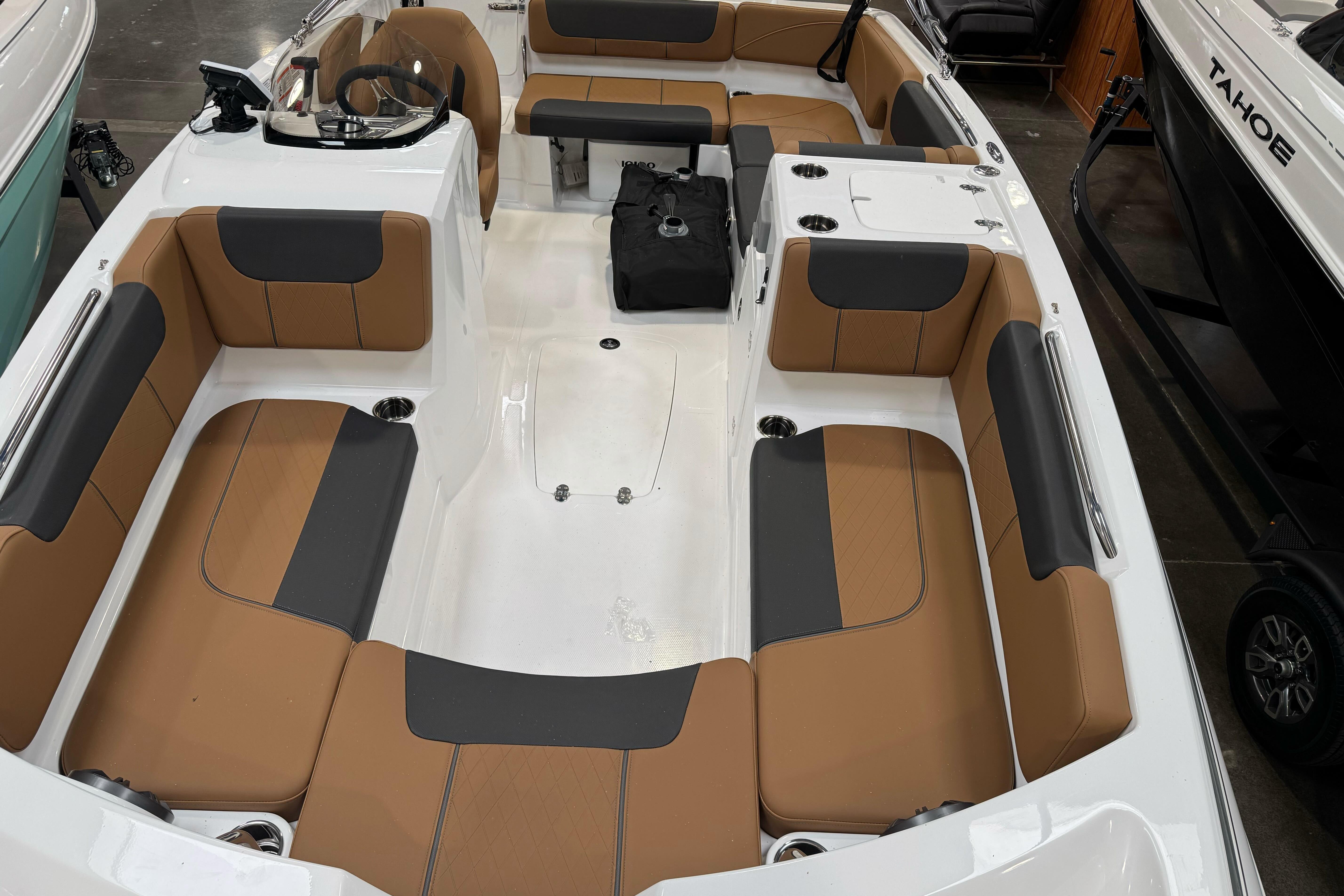 2026 Tahoe 2150 boat interior with tan and black seating, spacious layout.