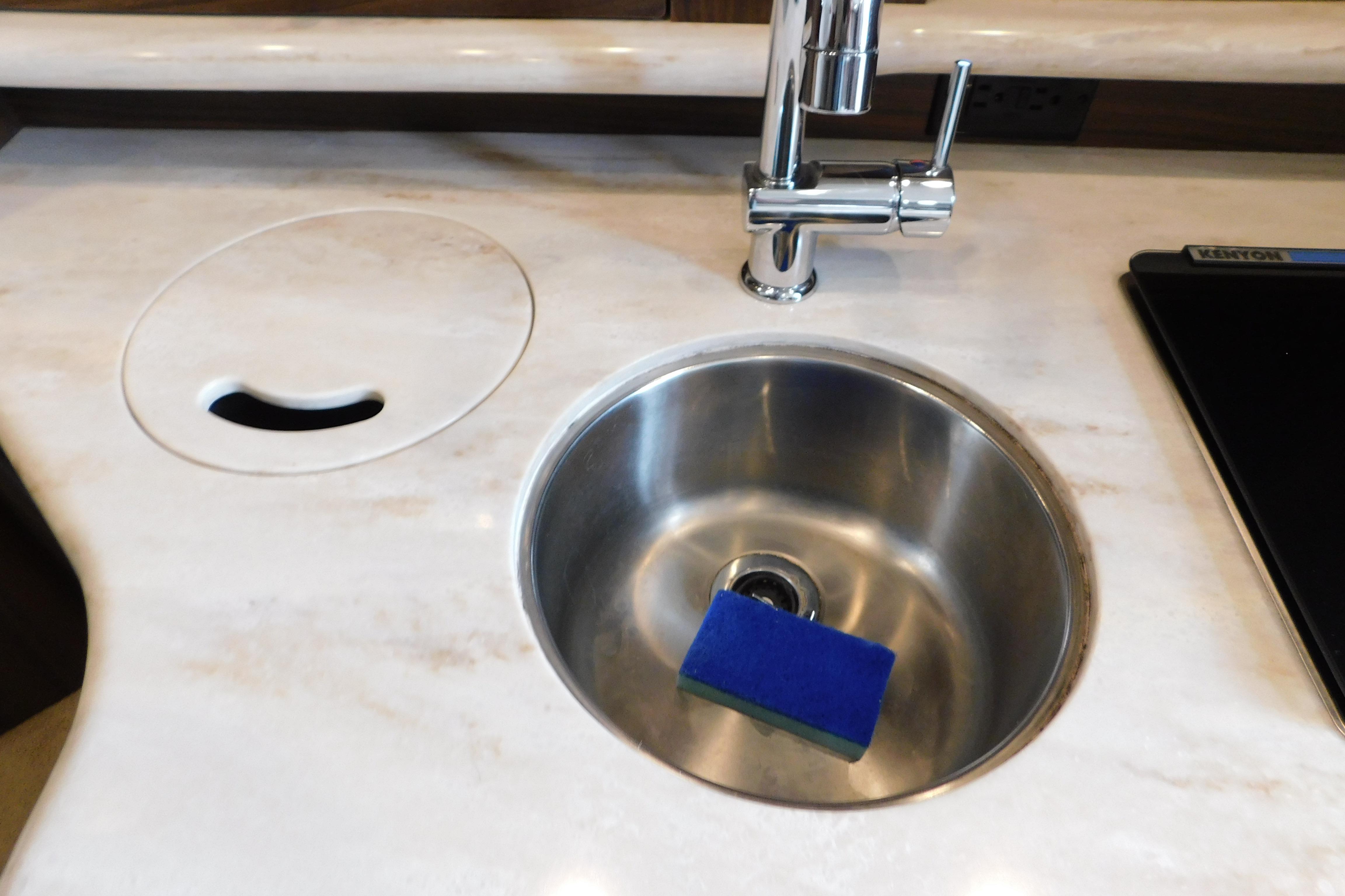 2017 Rinker EX 320 yacht kitchen sink with modern faucet and sponge.
