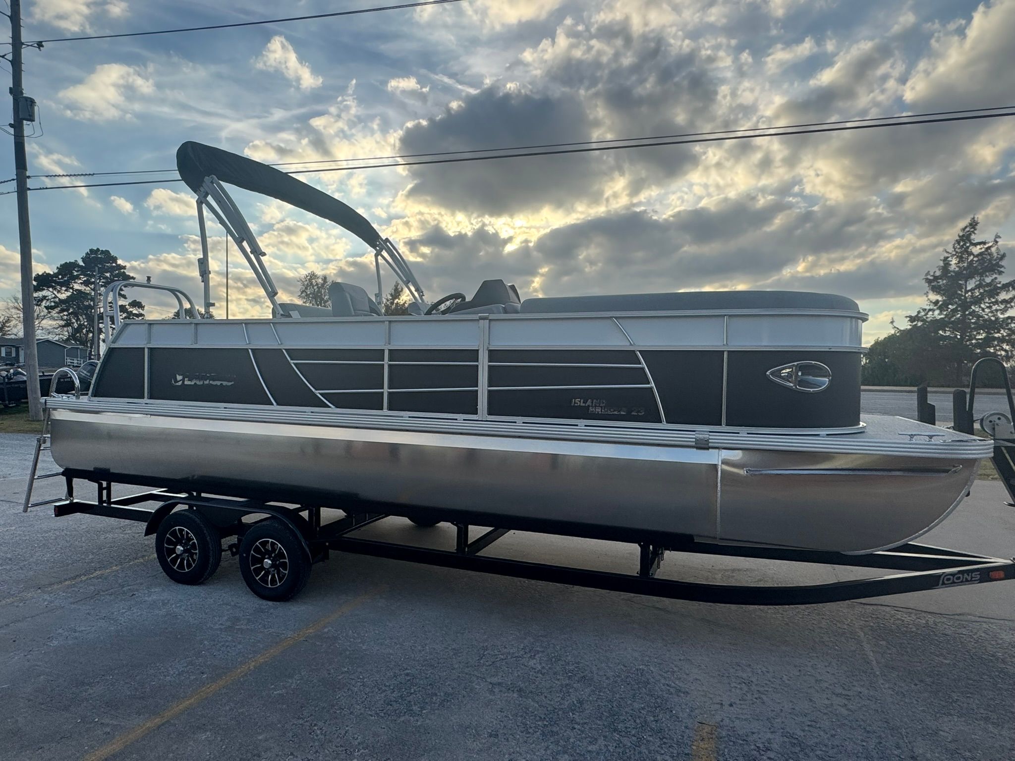 2026 Landau 23 Island Breeze pontoon boat at sunset.