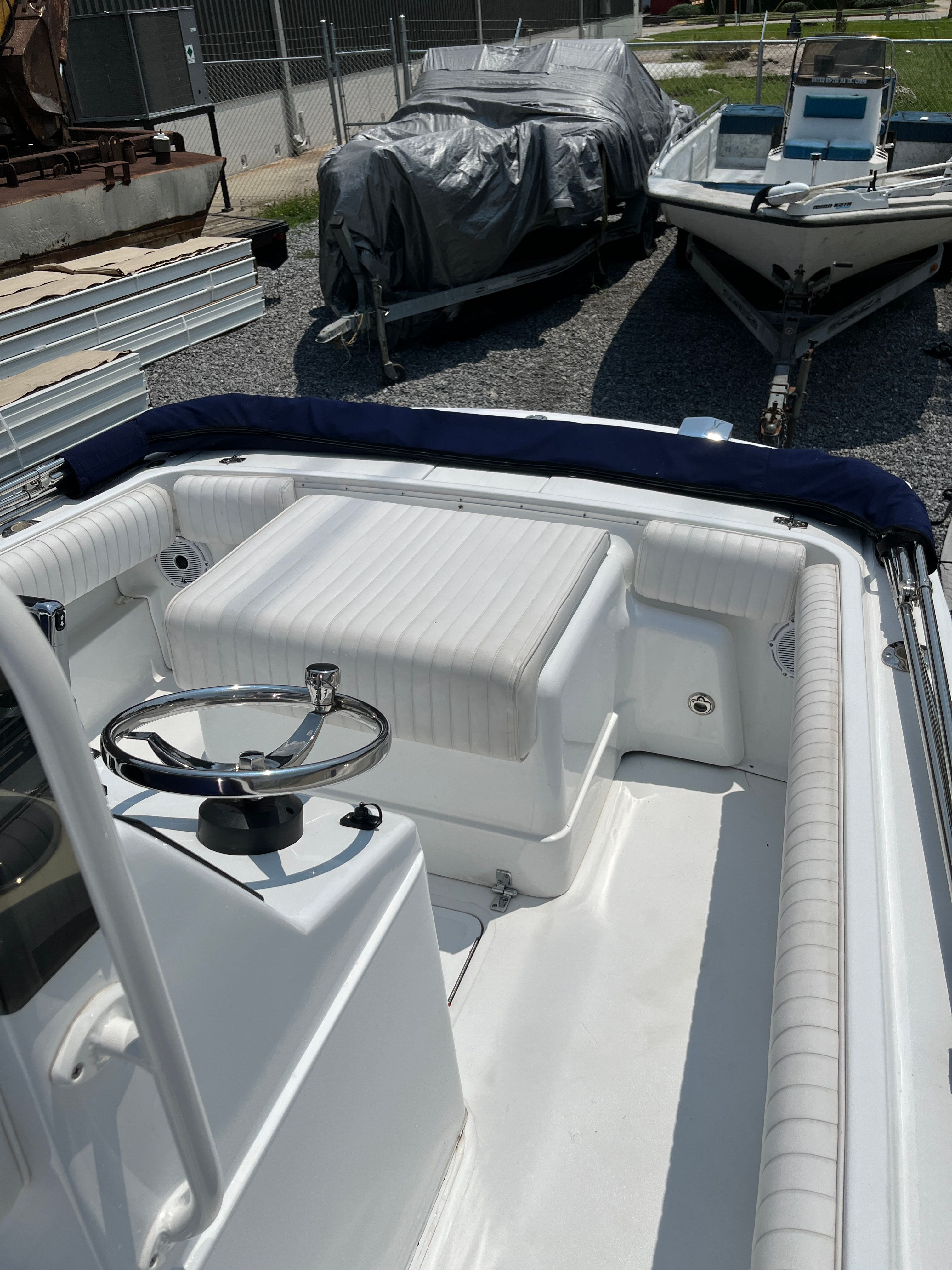 1970 Bertram Sportsman boat with white interior, parked outdoors.