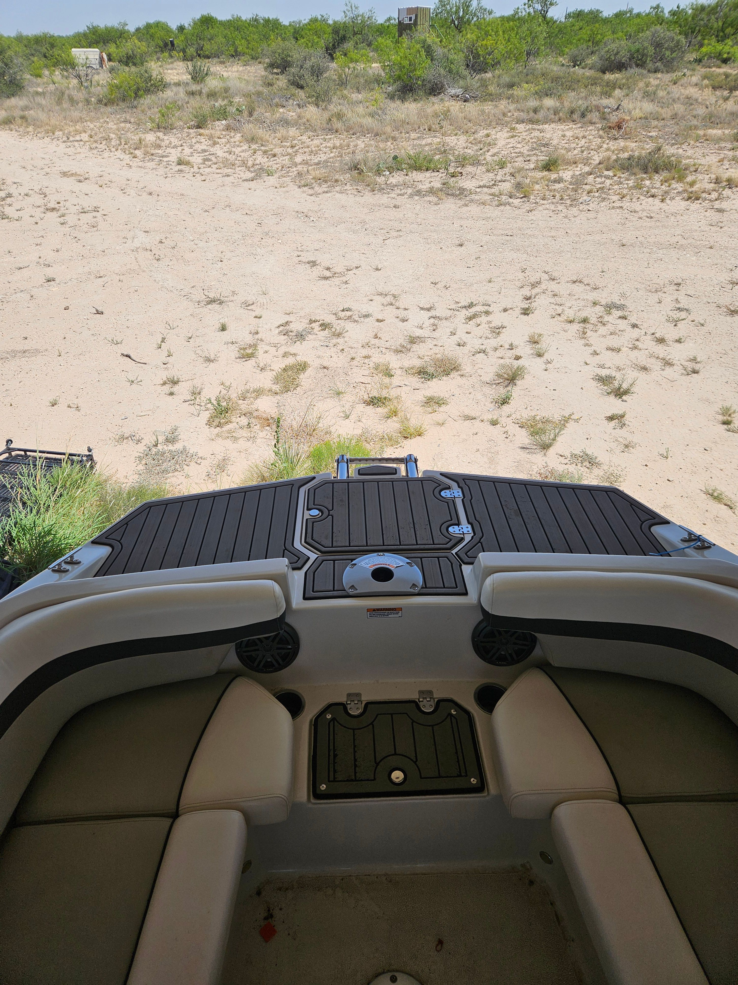 The image shows the stern of a 2023 Starcraft SVX211 boat on dry land.
