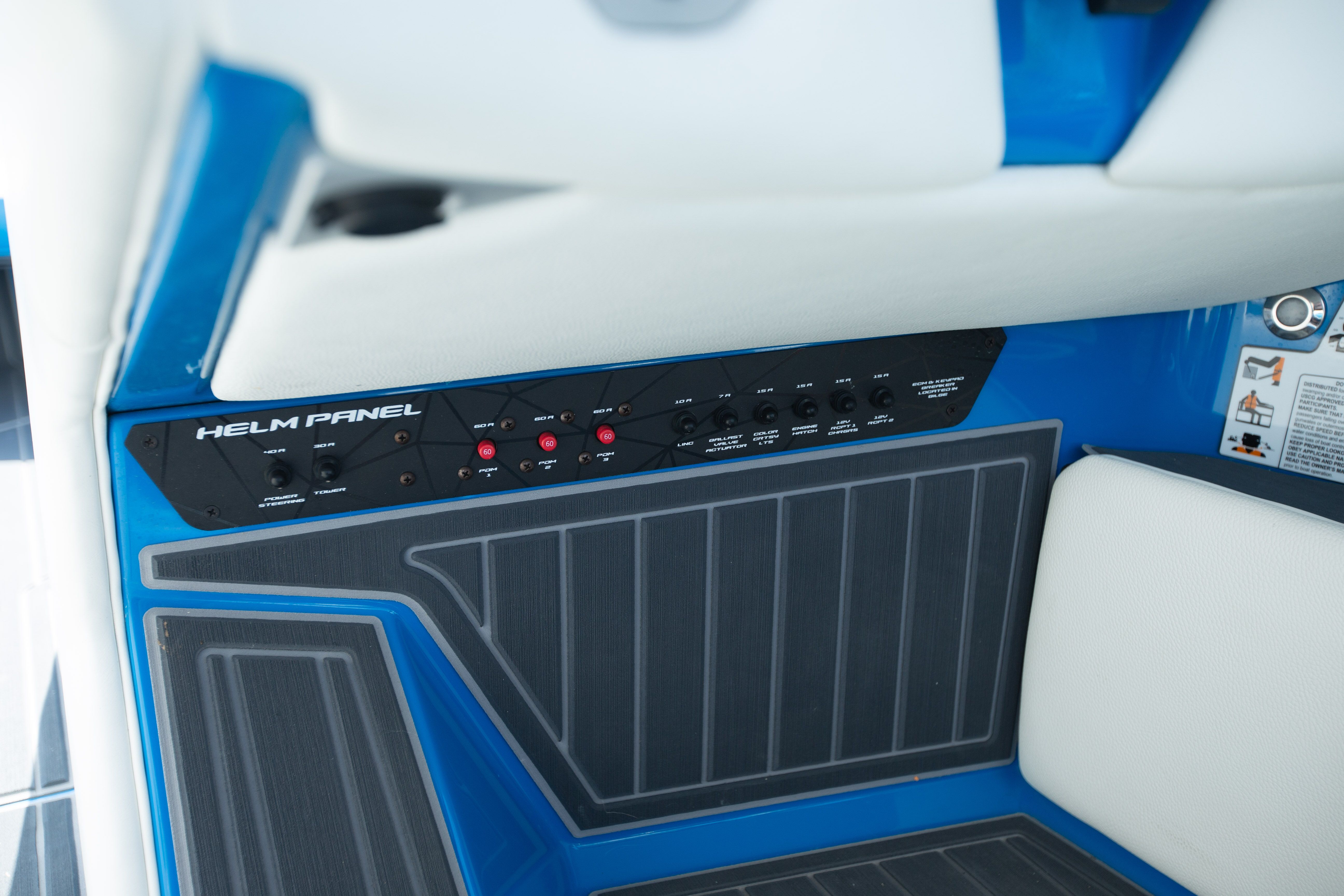 The image shows the helm panel of a boat with blue trim.