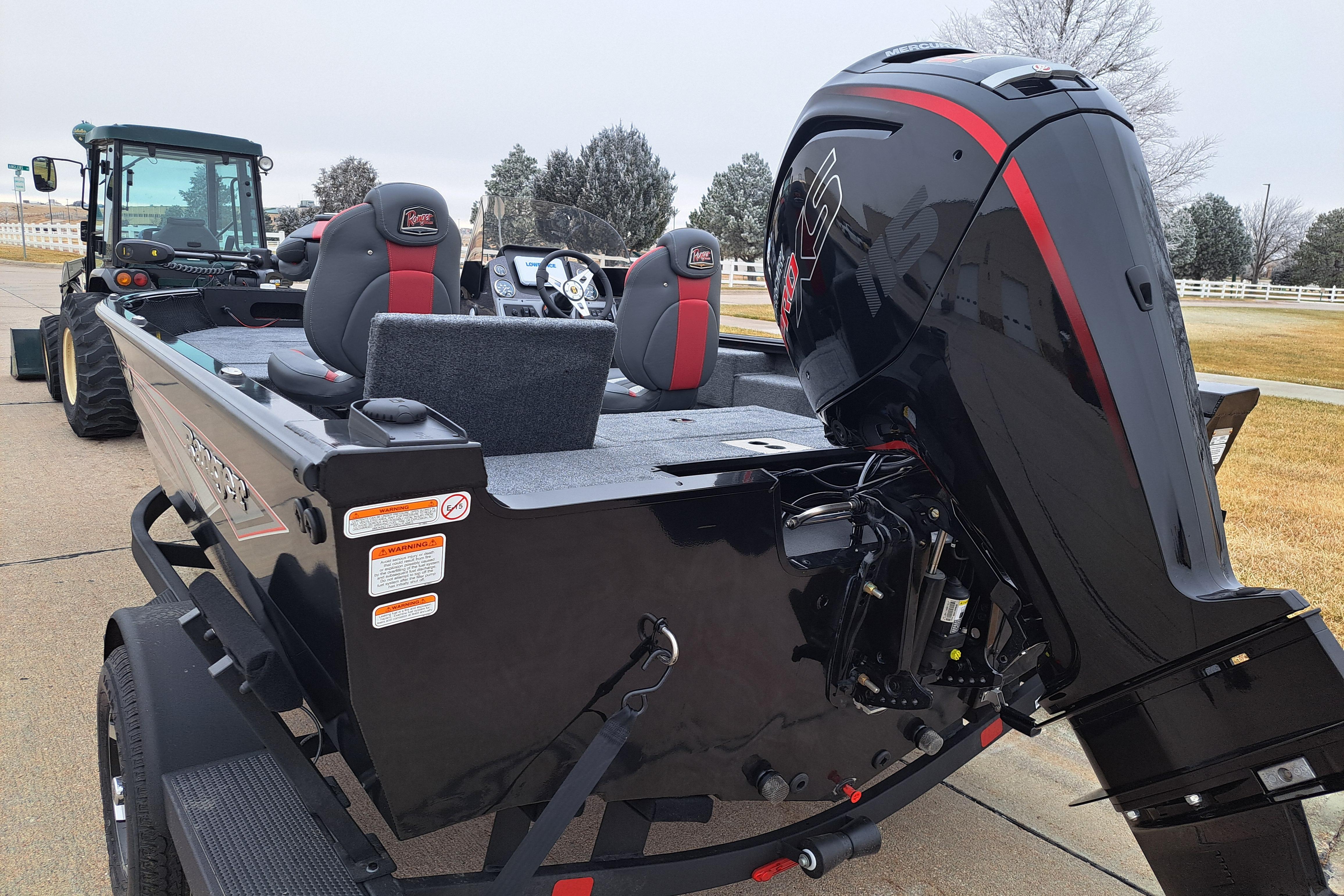 2026 Ranger VS1782SC Reata boat with powerful outboard motor, parked near a tractor.