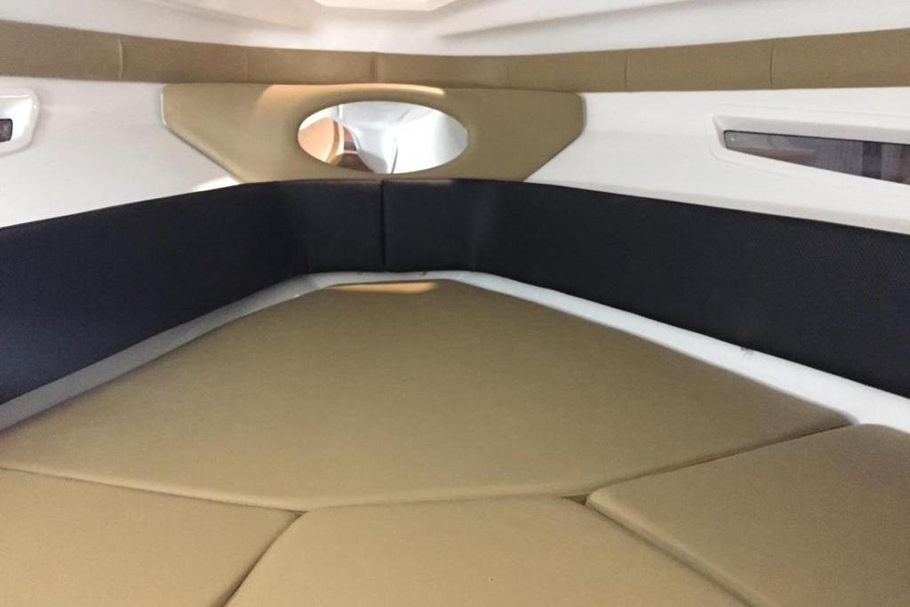 Interior cabin of 2026 Hanover 305 boat with beige and black seating.