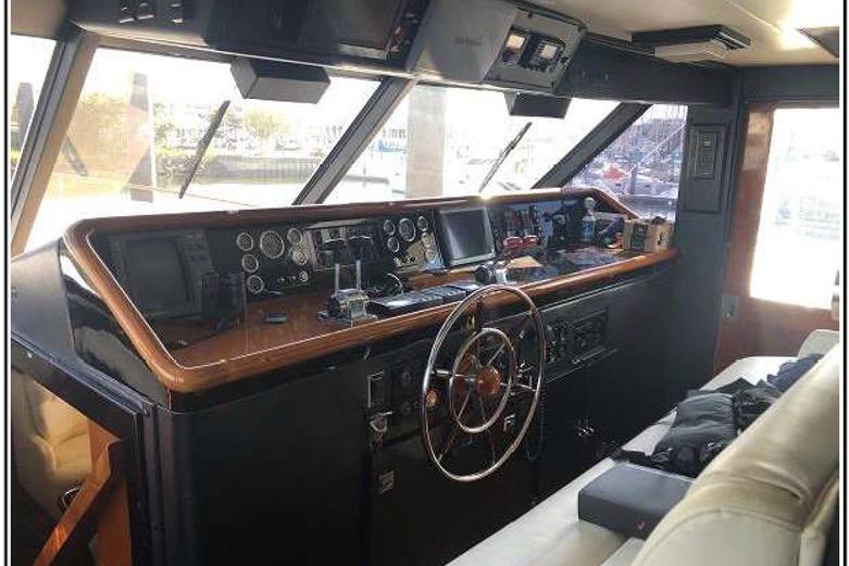 1974 Pacemaker Cockpit Motoryacht interior with steering wheel and control panel.